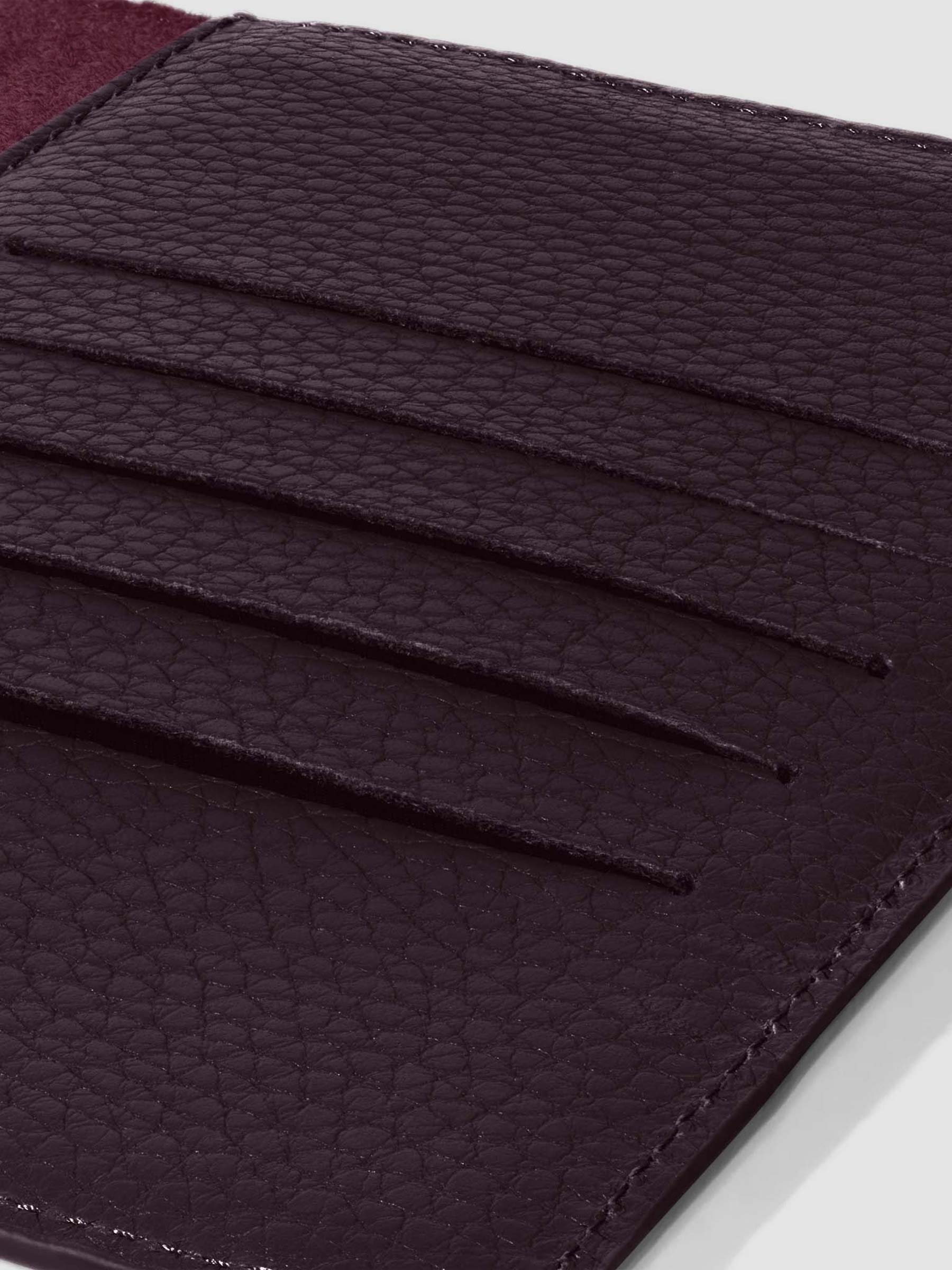 Closeup of credit card slots inside leather folio.