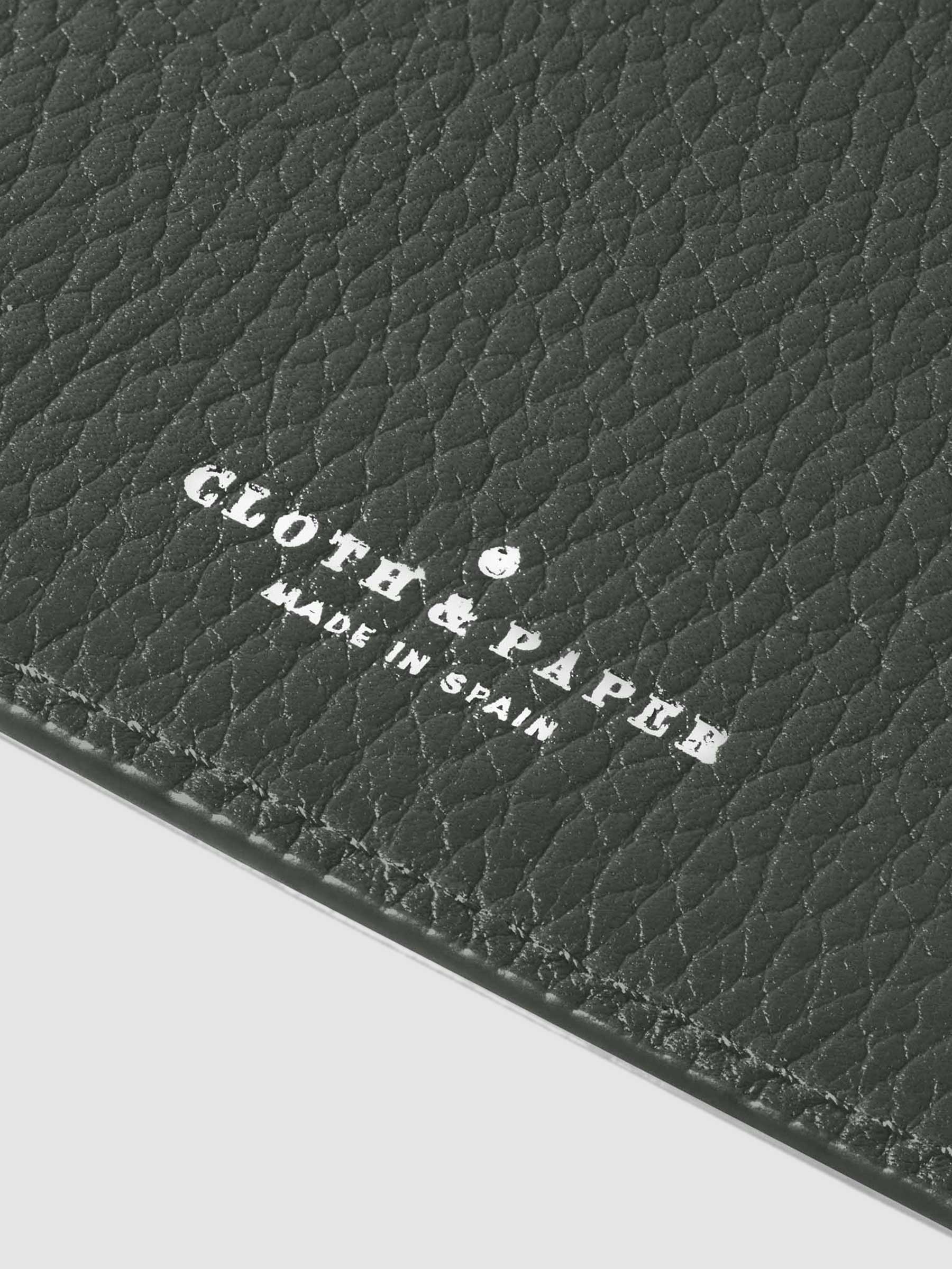 Closeup of silver stamping on leather folio.