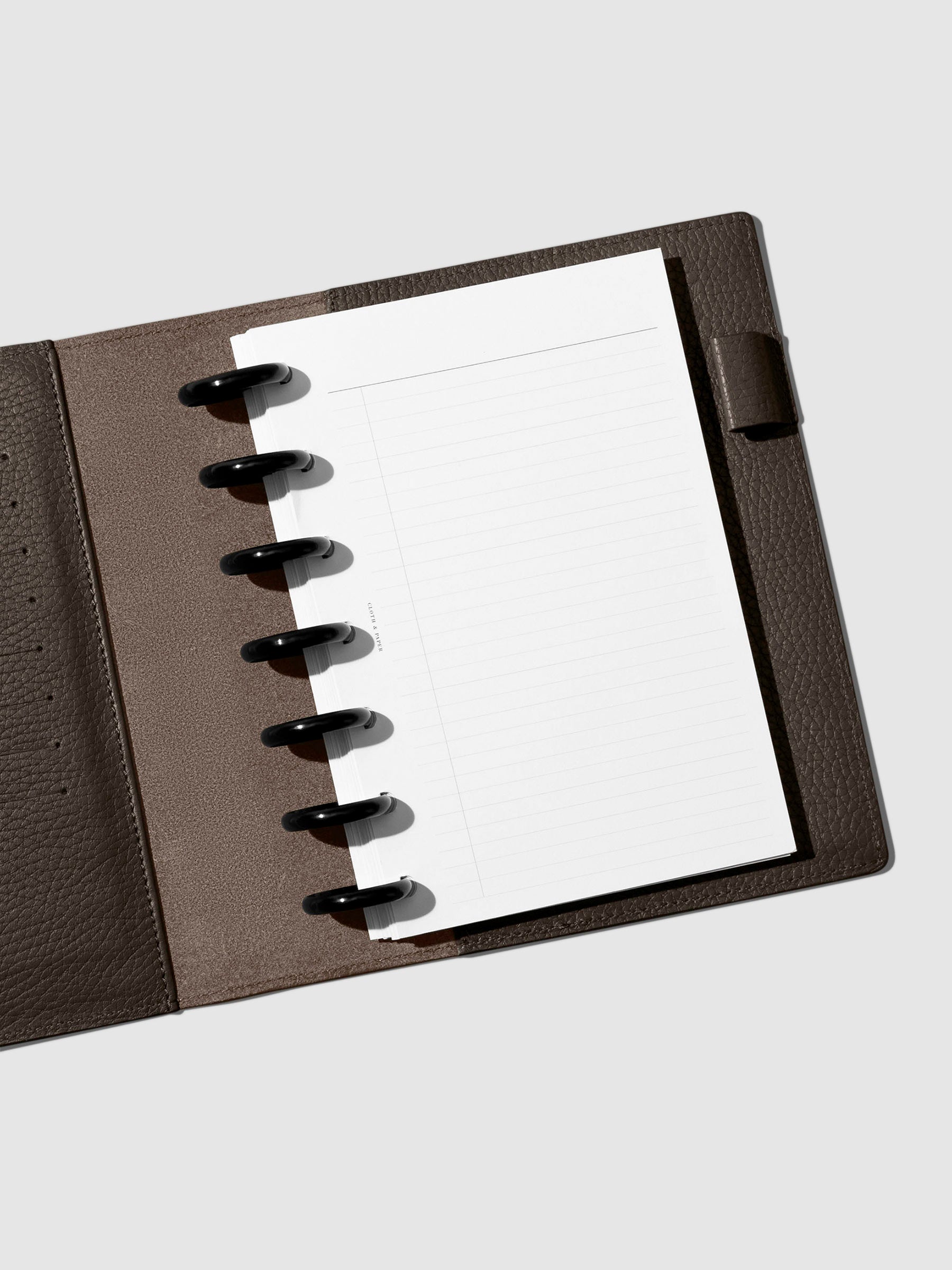 Folio displayed opened on a neutral background.