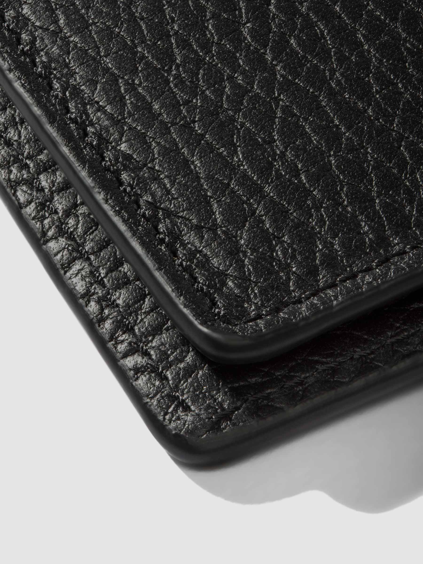 Closeup of Padrillo folio showing the hand-cut credit card slots.