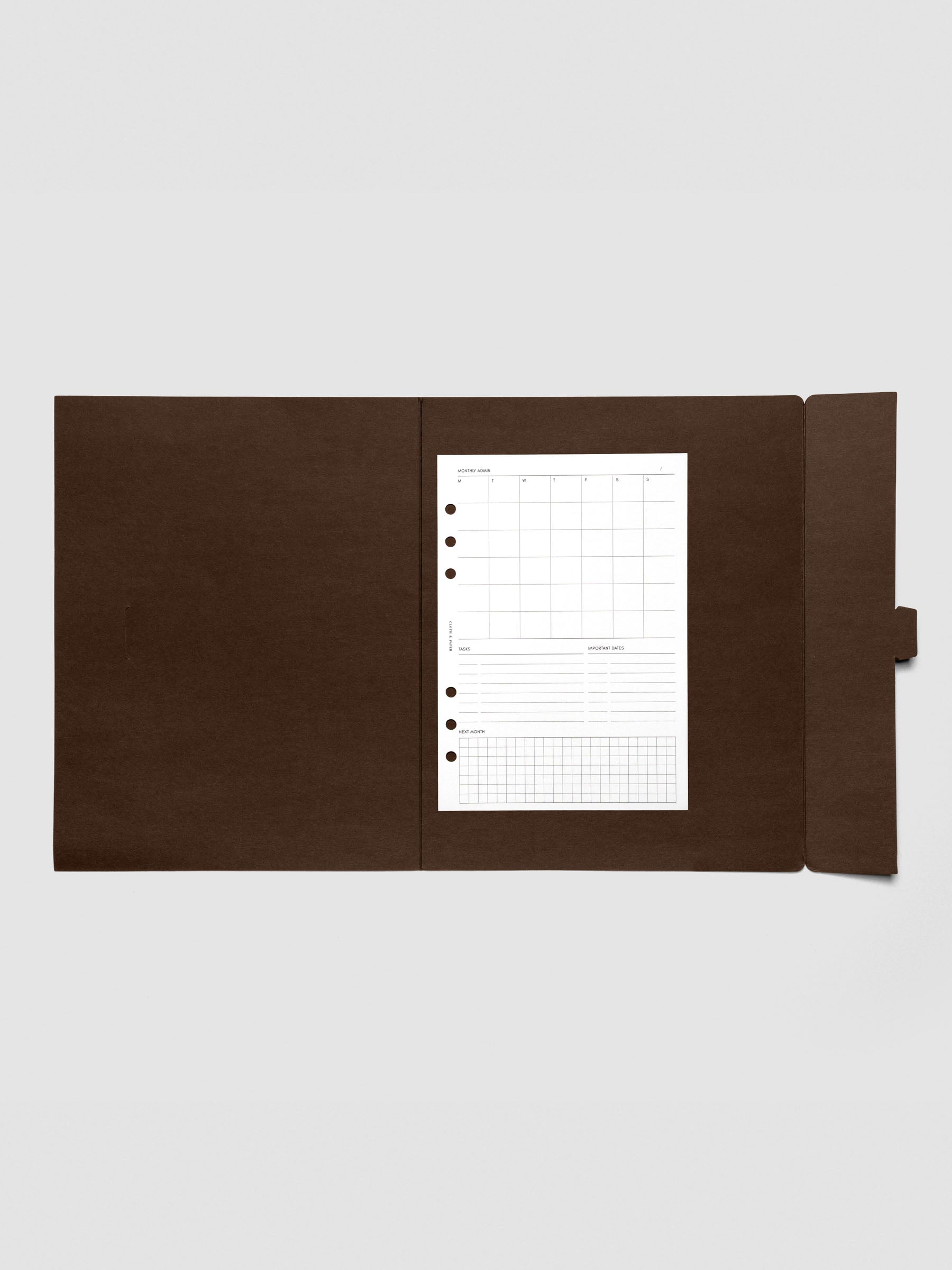 Espresso index folder open with a sample planner insert placed inside to show scale and storage capacity.
