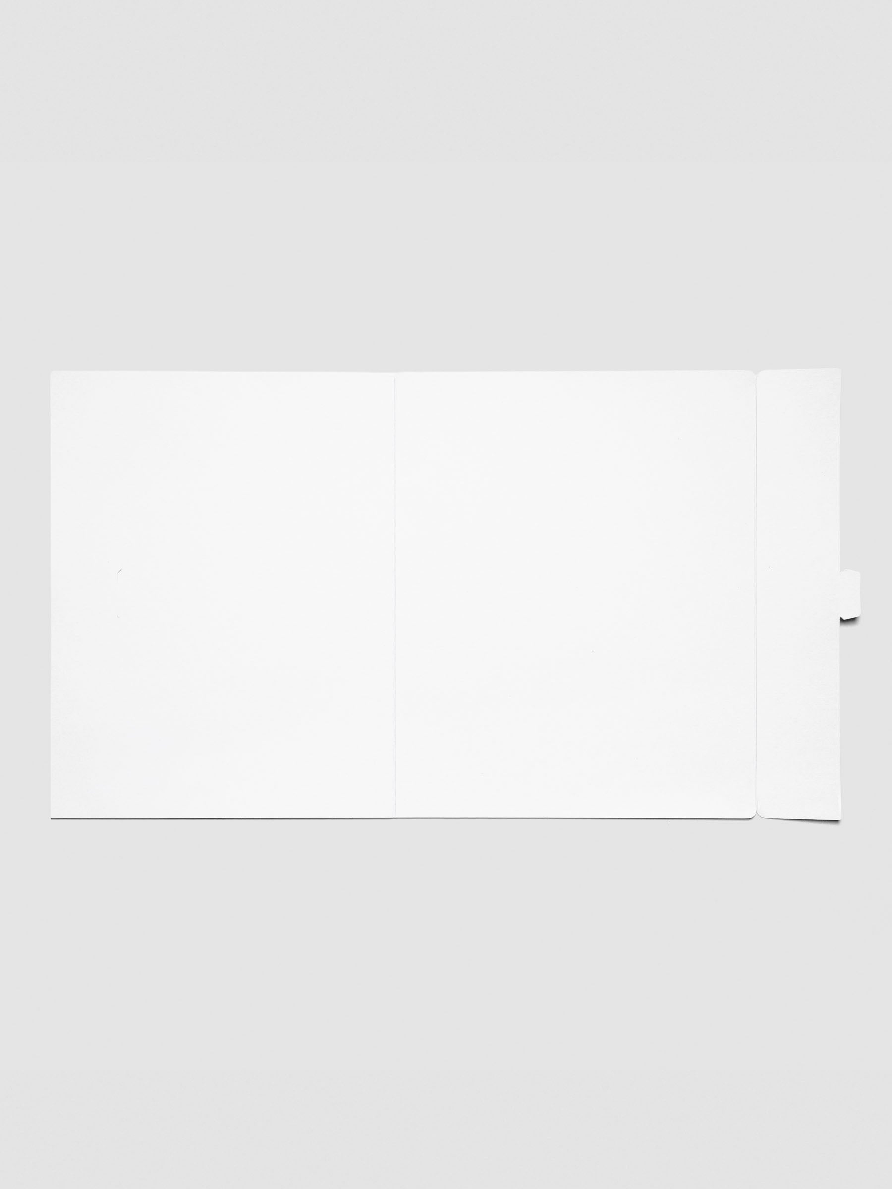 Inside view of the white Index Folder laid flat, showing the blank interior and secure tuck-in tab for closure.