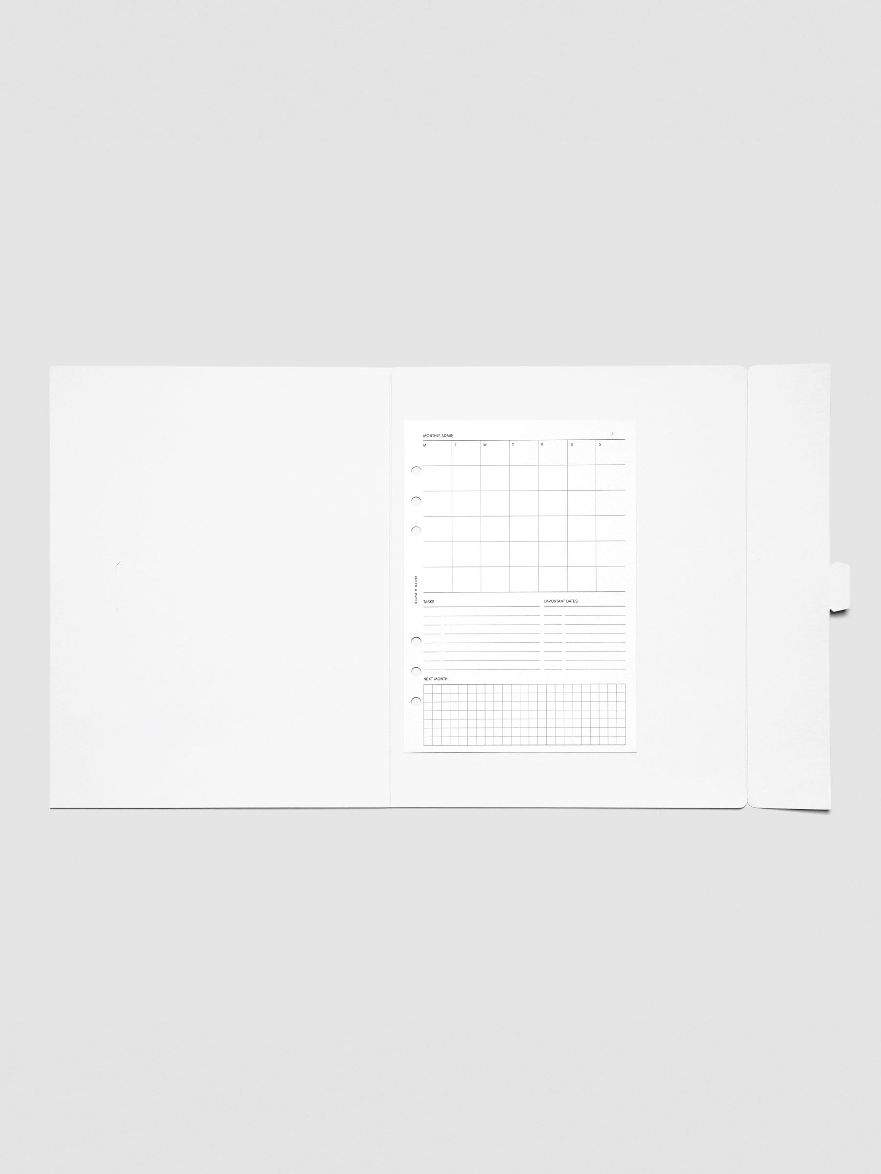 Inside view of the white Index Folder containing a planner insert, demonstrating how it can be used to store stationery or loose documents.