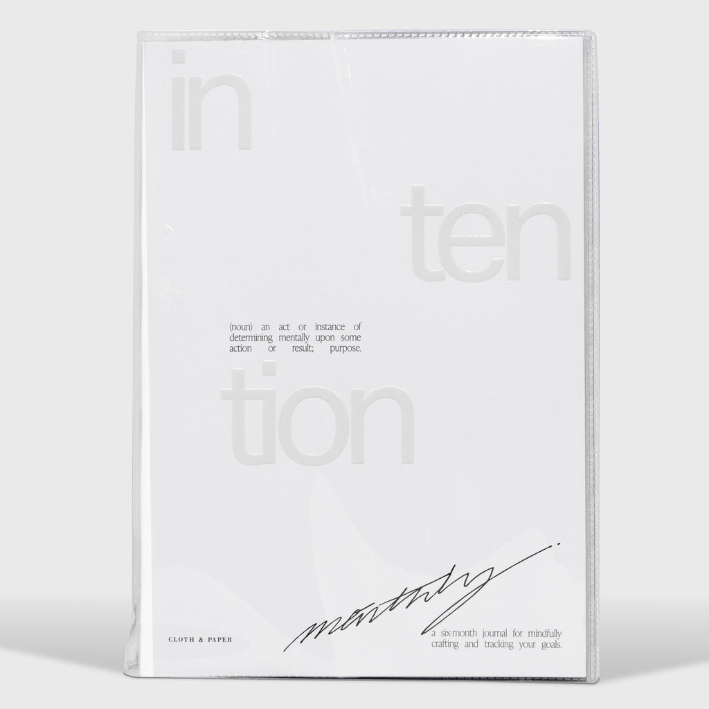 Intention Notebook, Cloth and Paper. Notebook in clear vinyl case displayed on a neutral background.