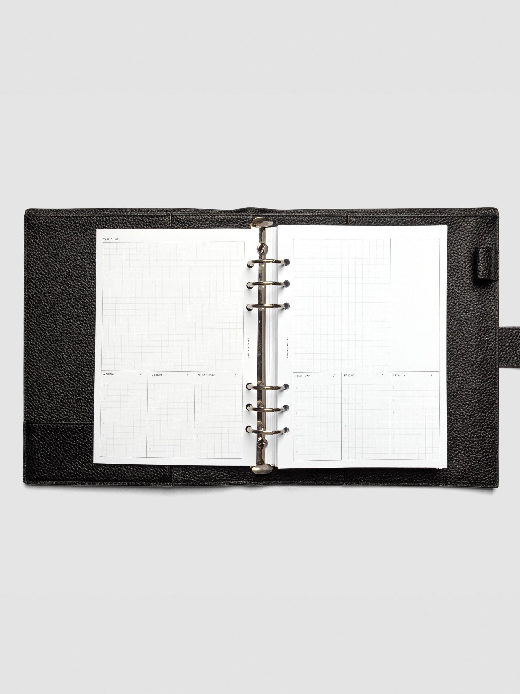 A full weekly spread of the Ivy Lee Priority Planner Inserts displayed in an open planner, with a large "Task Dump" grid section at the top and seven labeled sections for daily priorities below.