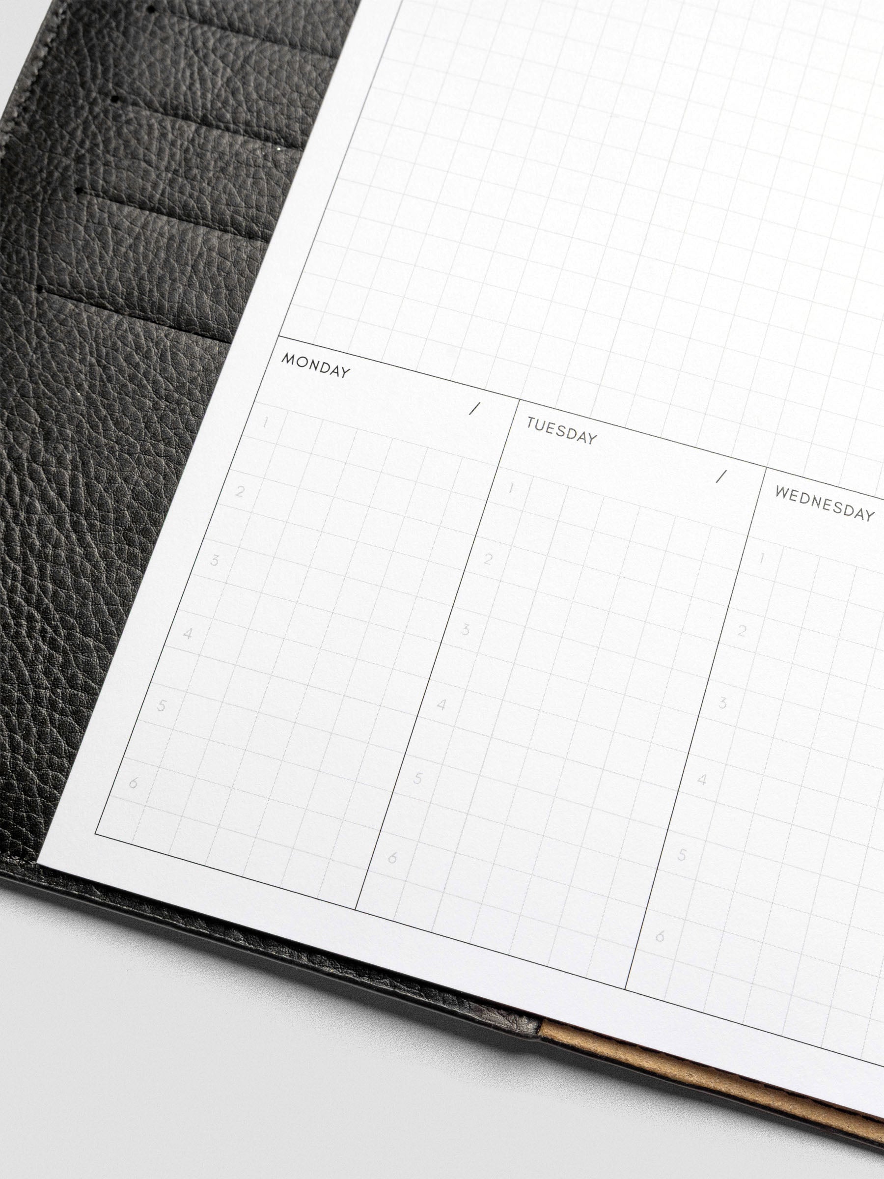 A close-up of the bottom half of the planner showing the Monday through Wednesday sections, each with six numbered grid lines for task prioritization.