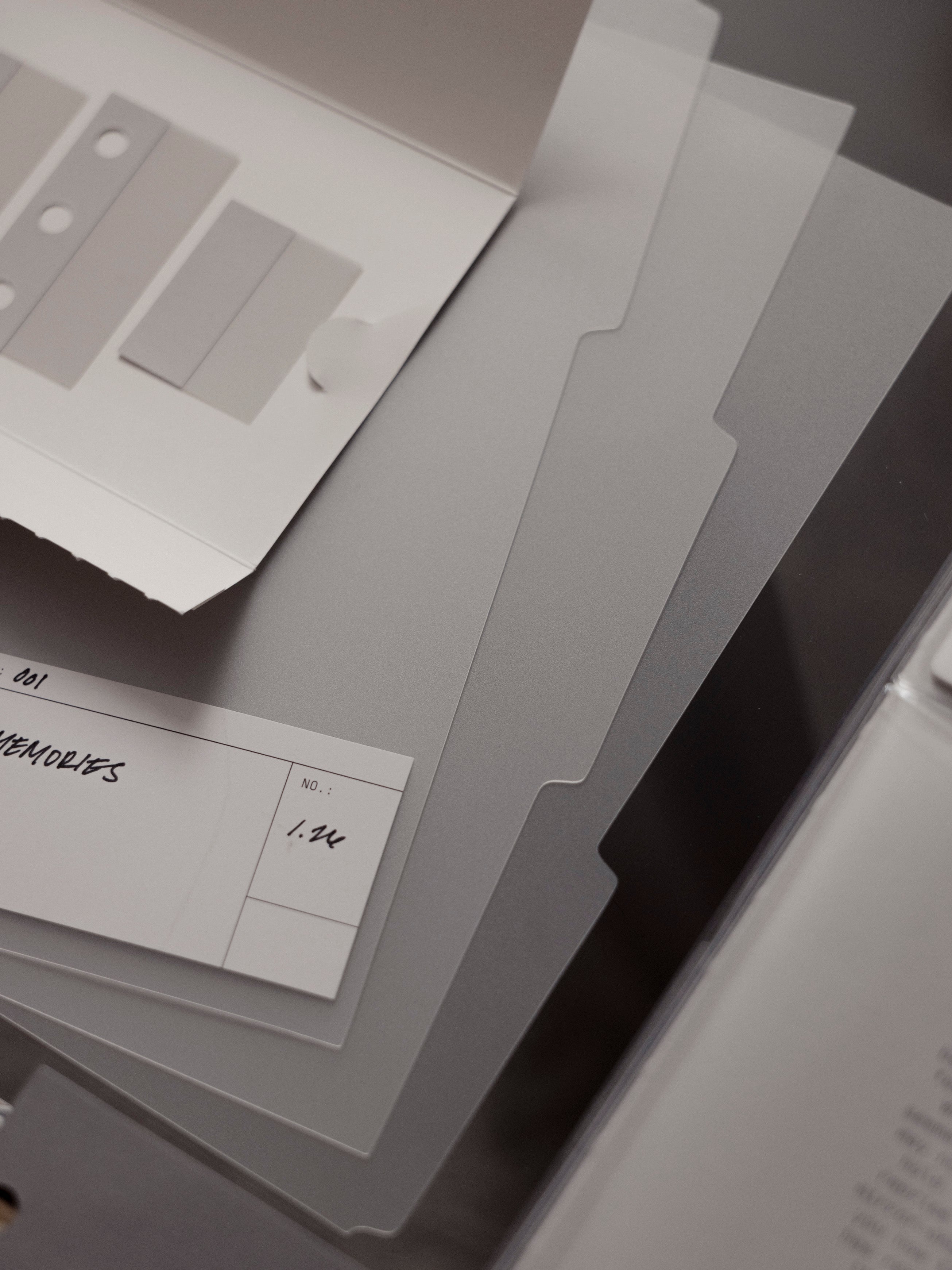 Set of three matte transparent blank side tab dividers with blank white labels shown against a dark background.