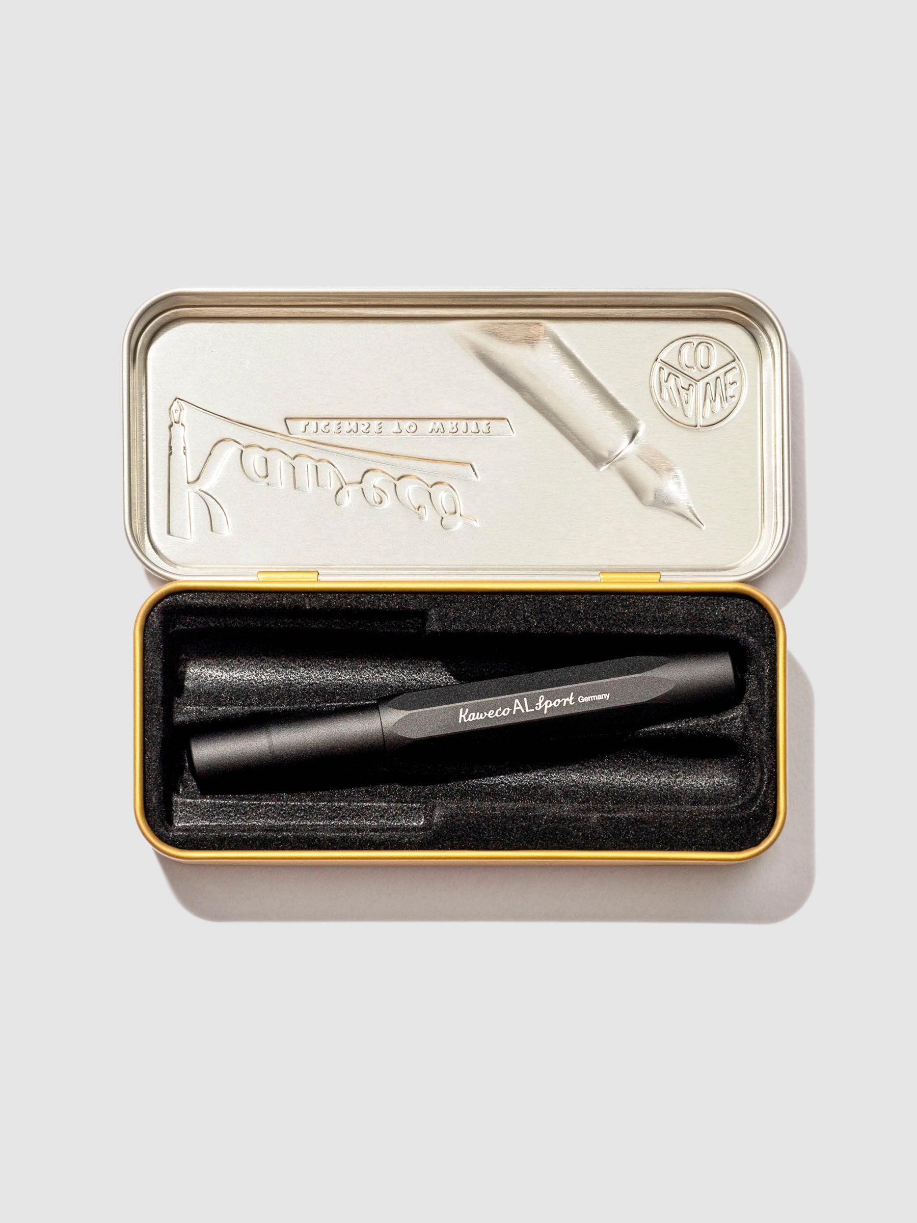 Kaweco AL Sport Fountain Pen, Black, Extra Fine Nib, Cloth and Paper. Pen displayed in its tin case on a neutral background.
