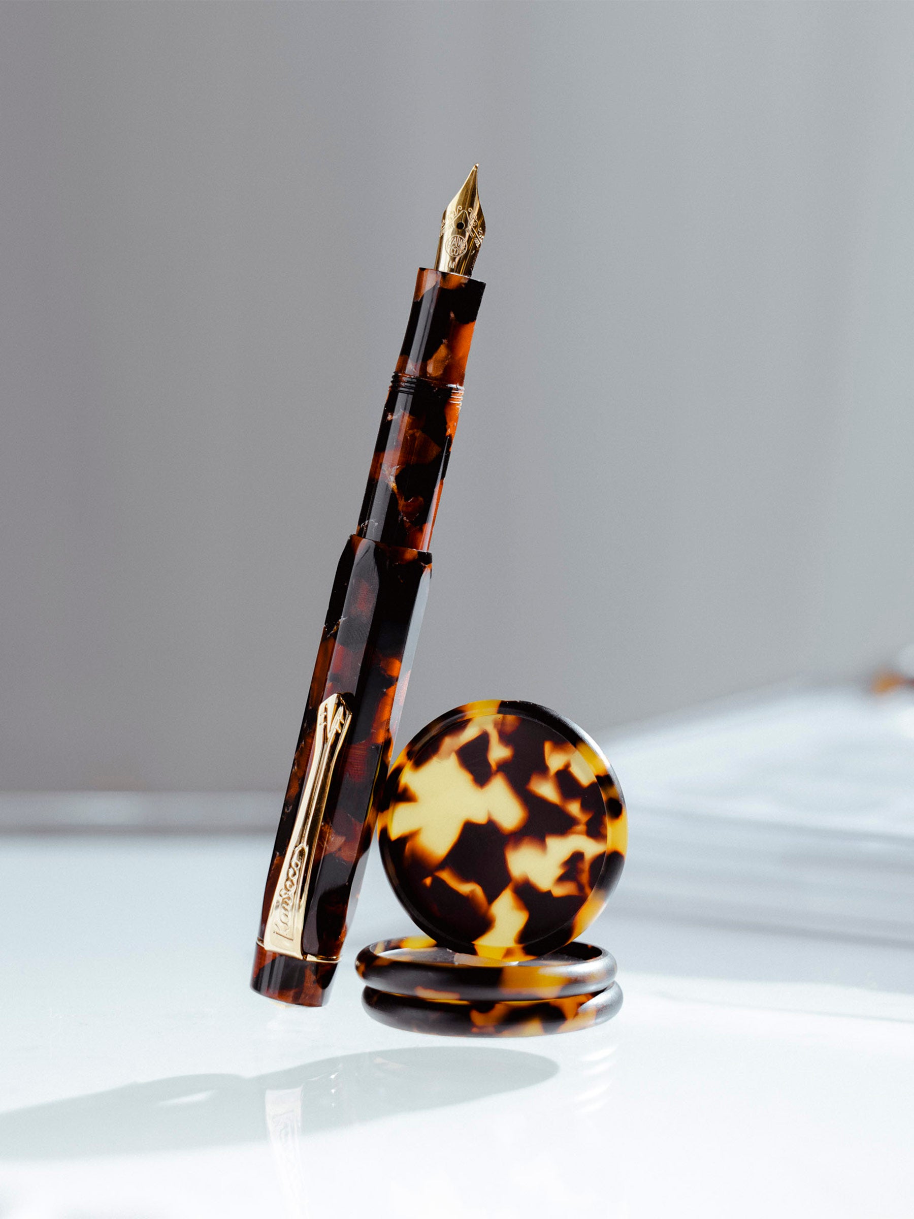 Hickory Brown pen shown alongside Tortoiseshell Planner Discs.