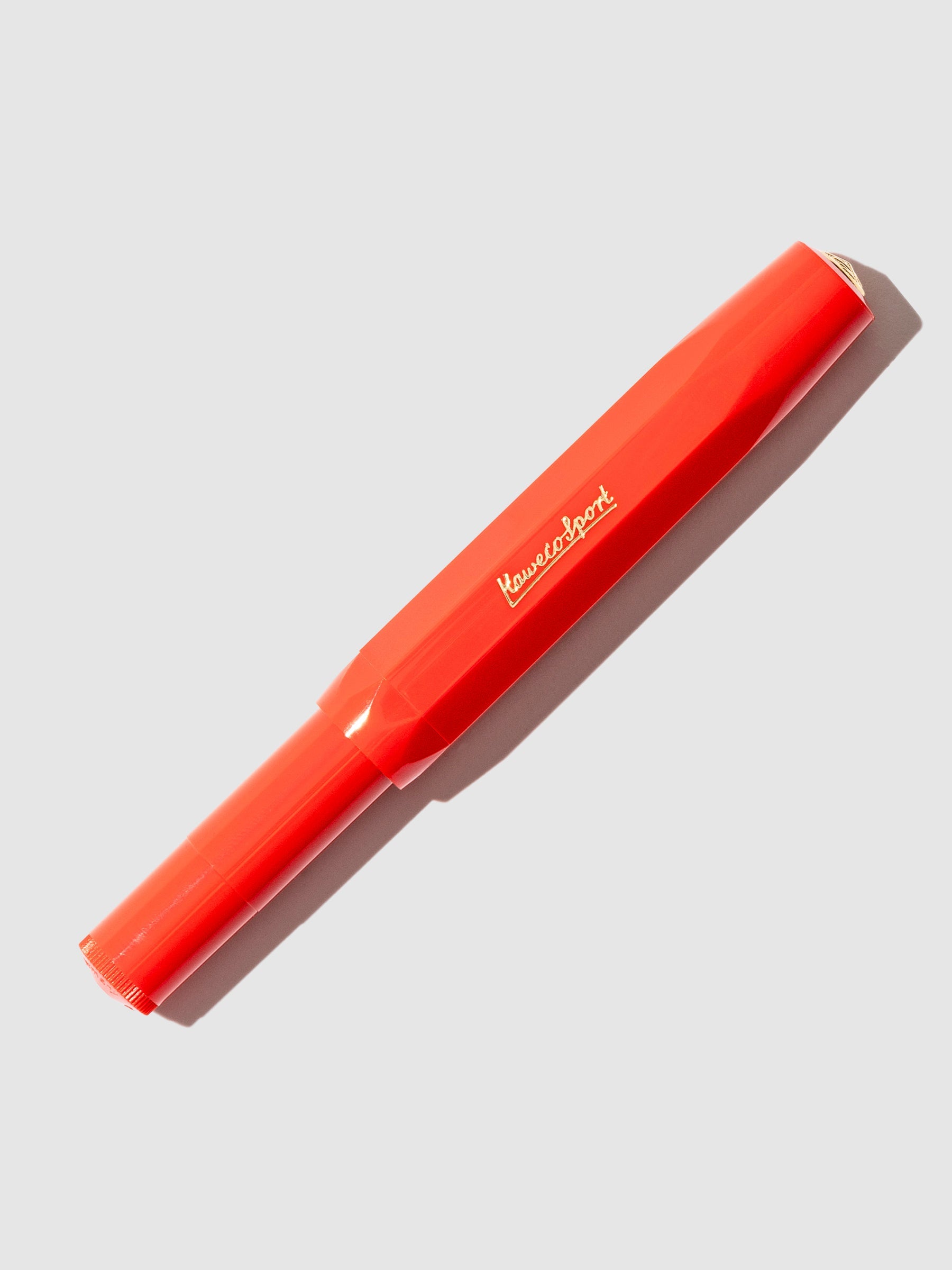 Red pen displayed on a neutral background.