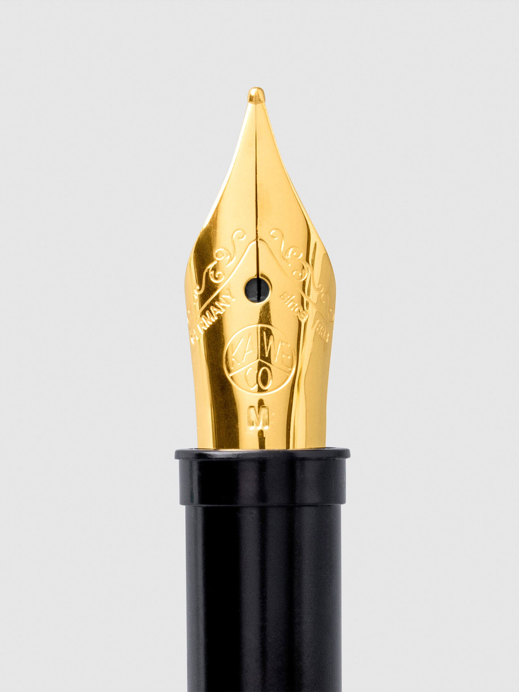 Kaweco Replacement Nib, Gold, Medium, Cloth and Paper. Closeup of nib on a neutral background.