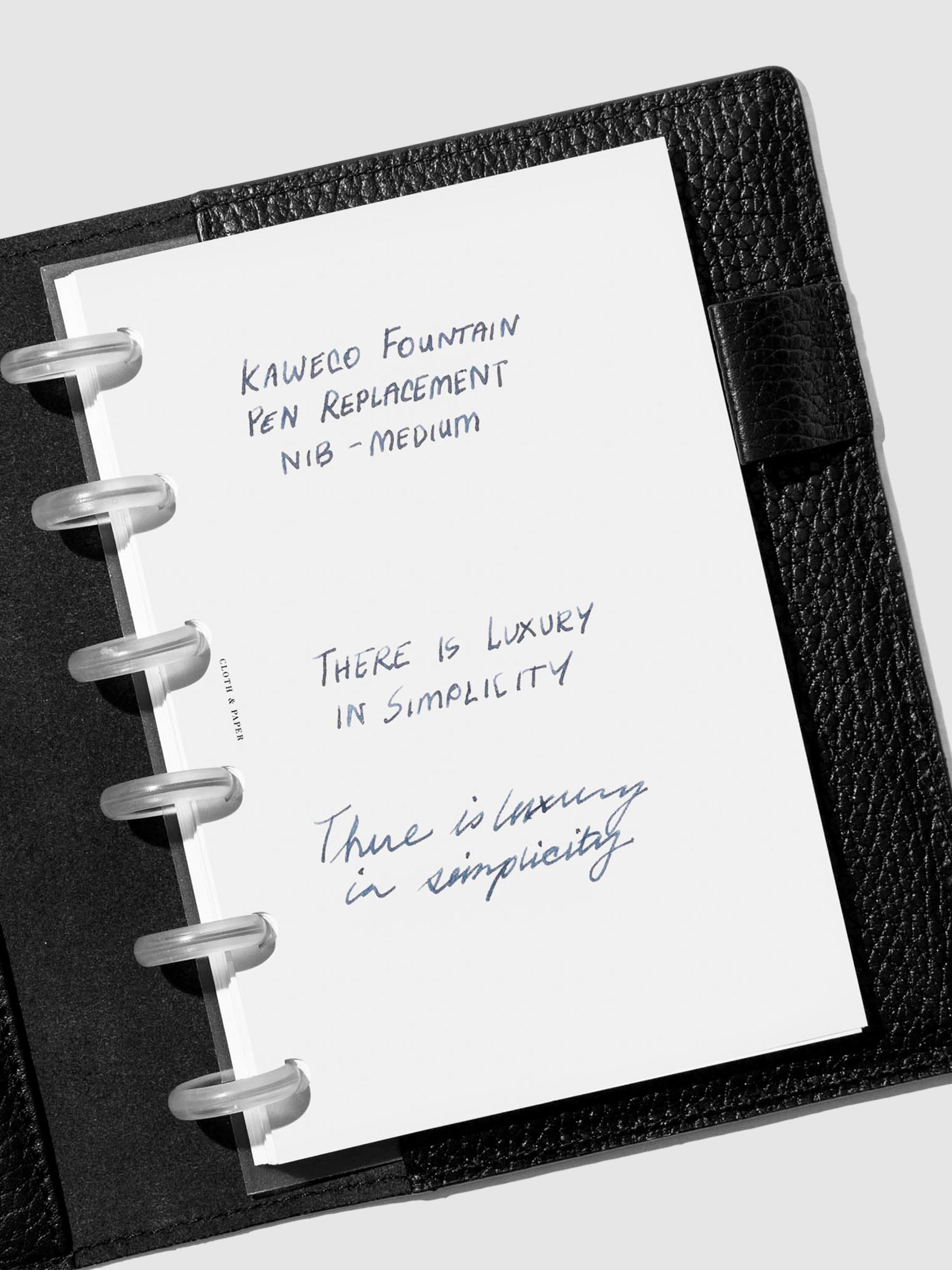 Medium nib writing sample shown in a black leather folio.