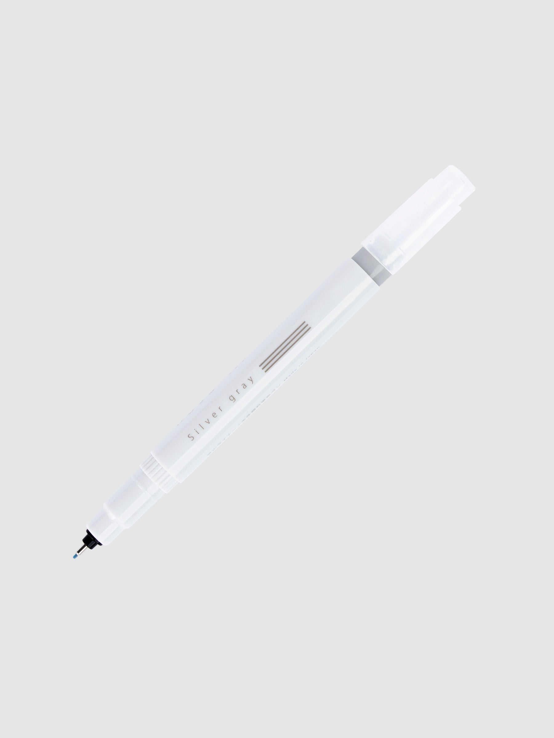Fineliner marker in Silver Gray with nib exposed and cap posted to the end of its barrel on a neutral background.