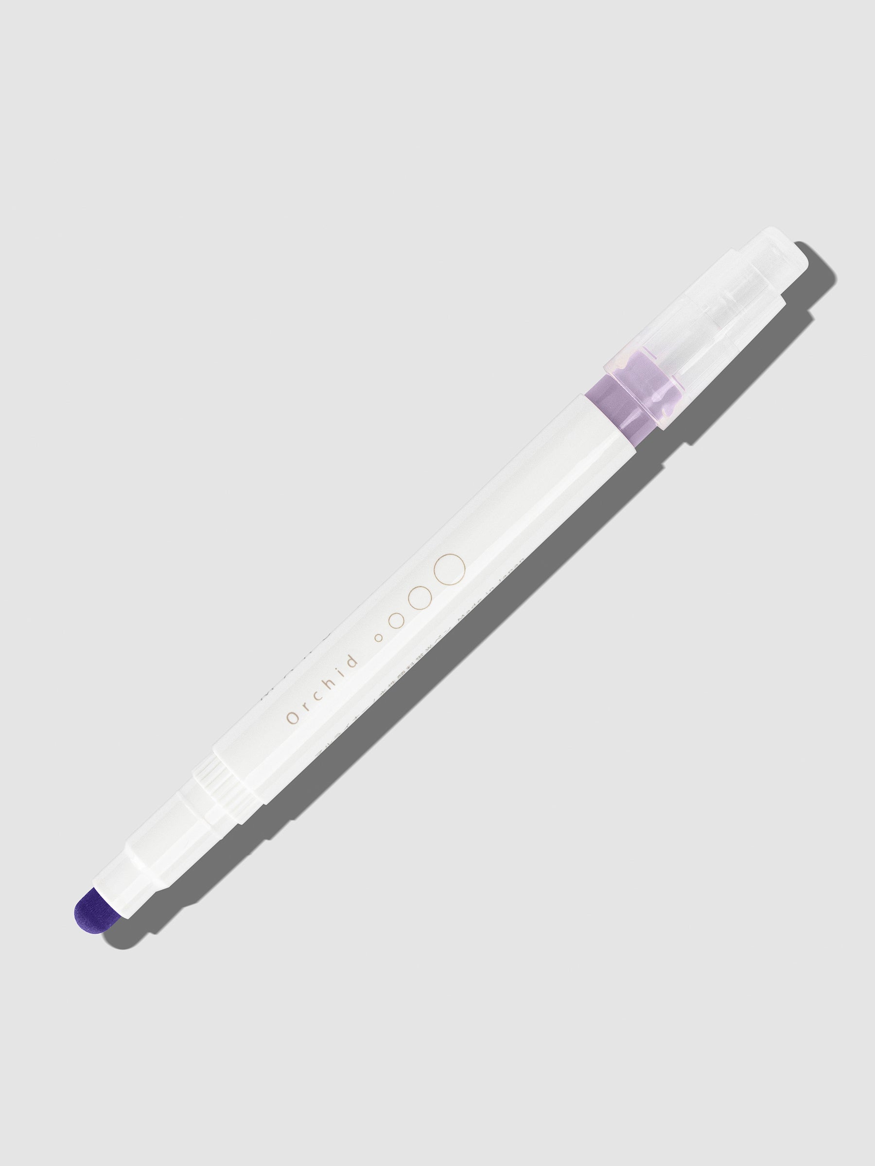 Orchid highlighter with tip exposed and cap posted to the end of its barrel on a neutral background.