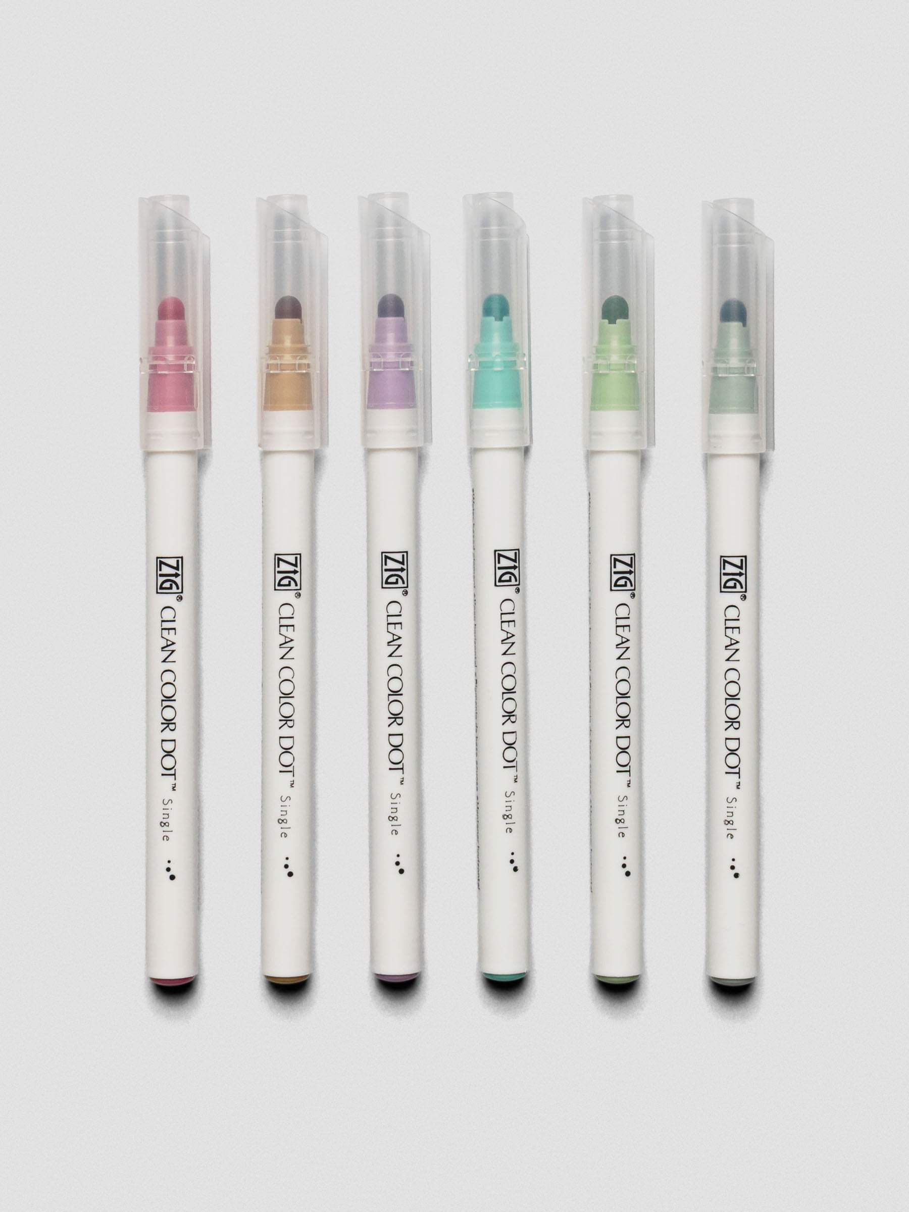Set of six Kuretake ZIG Clean Color Dot Markers displayed vertically with caps on, showcasing pastel marker colors.