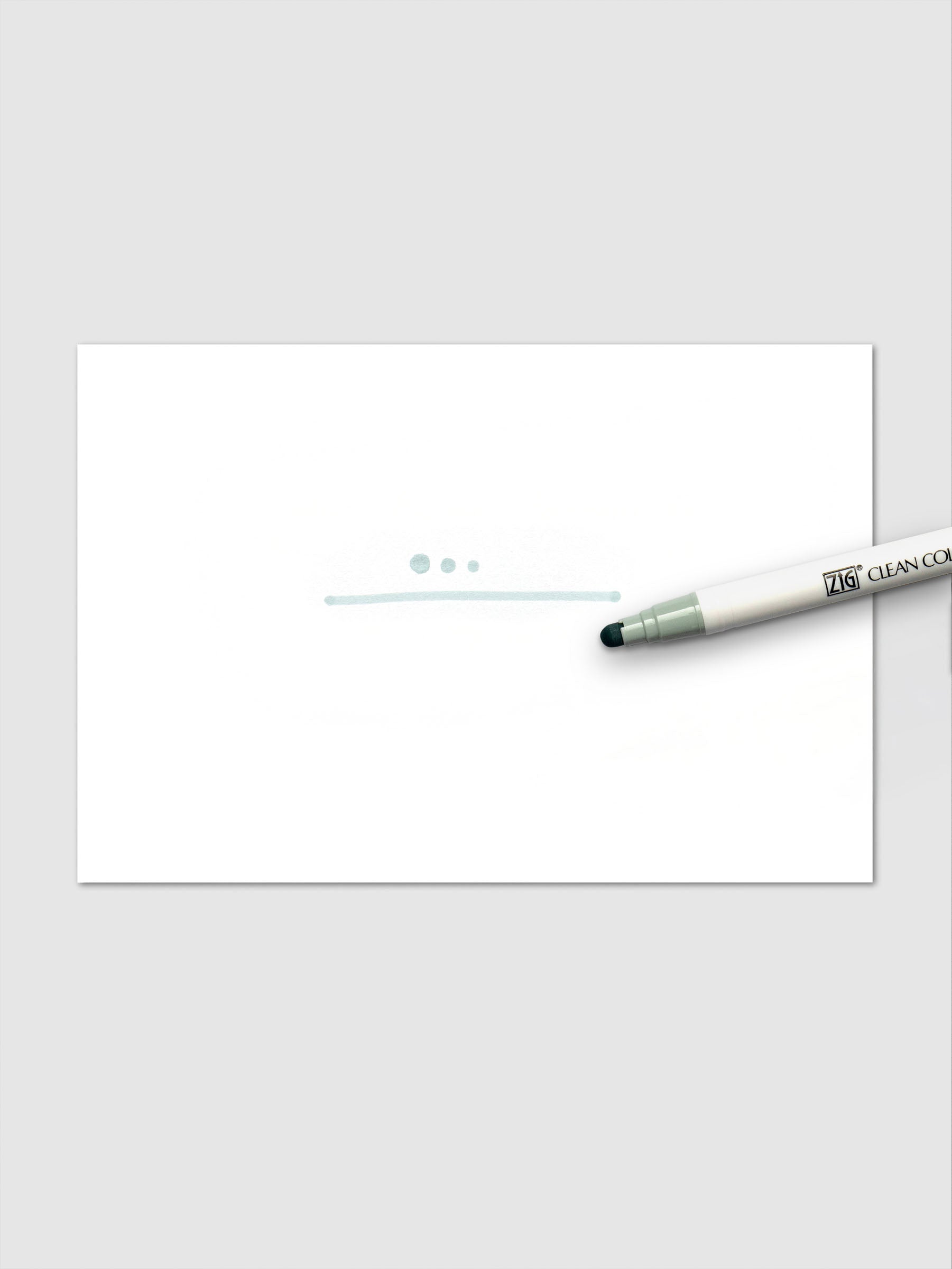 Grayish Green marker making dots and a line stroke on paper to demonstrate ink color and tip style.