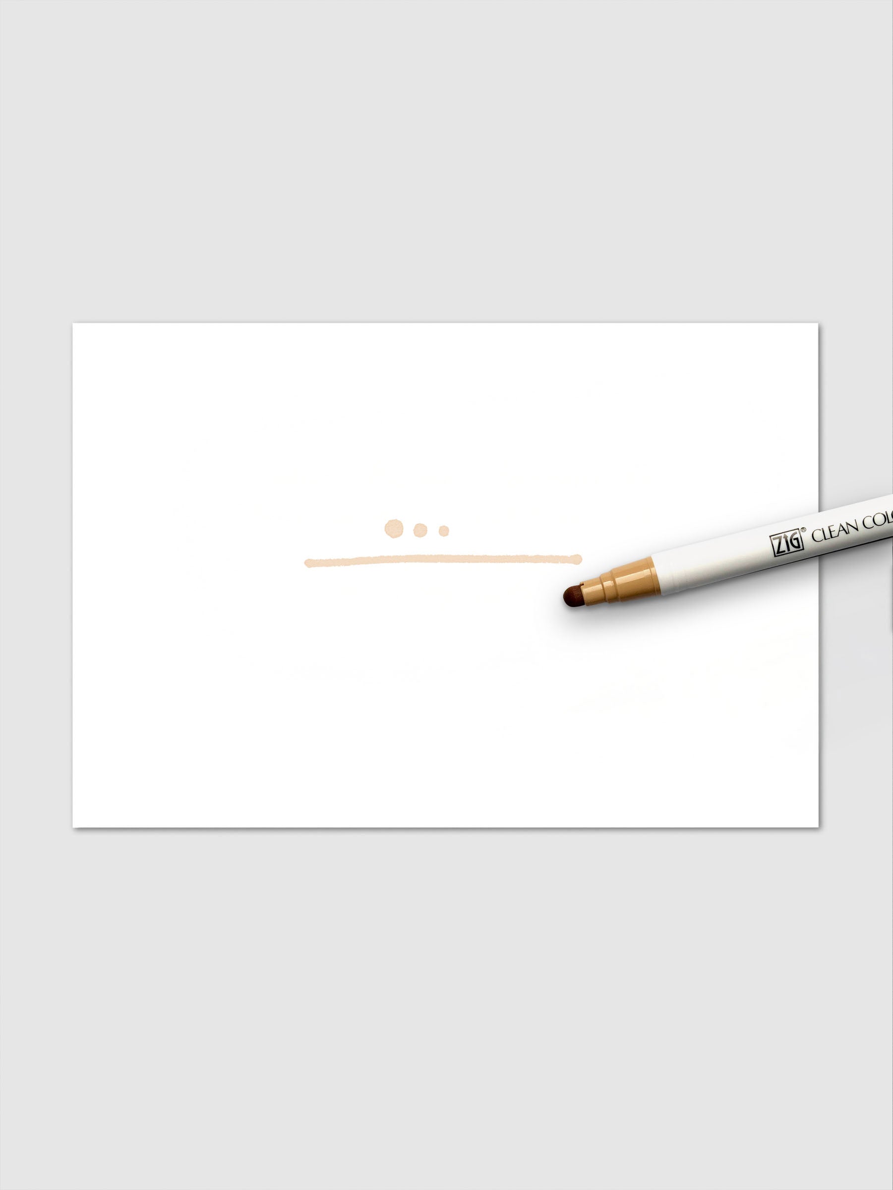 Oatmeal marker shown creating pastel dots and a smooth line on white paper surface.