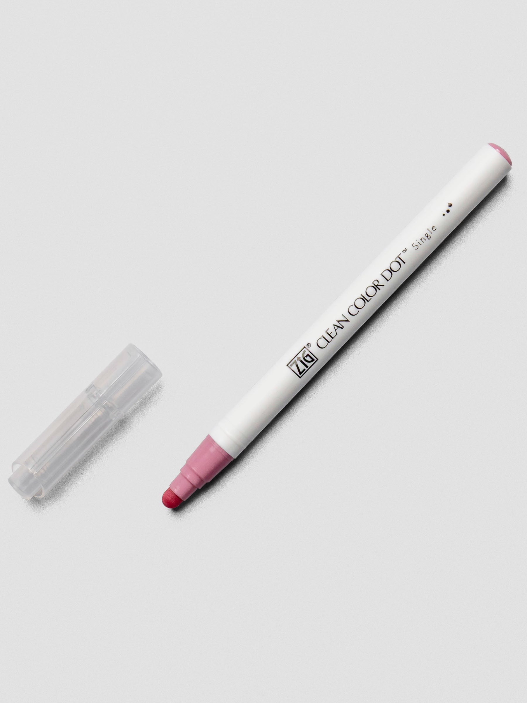 A Kuretake ZIG Clean Color Dot Marker in Pale Rose with the cap removed, showing the soft rounded dot tip and minimal white barrel design.
