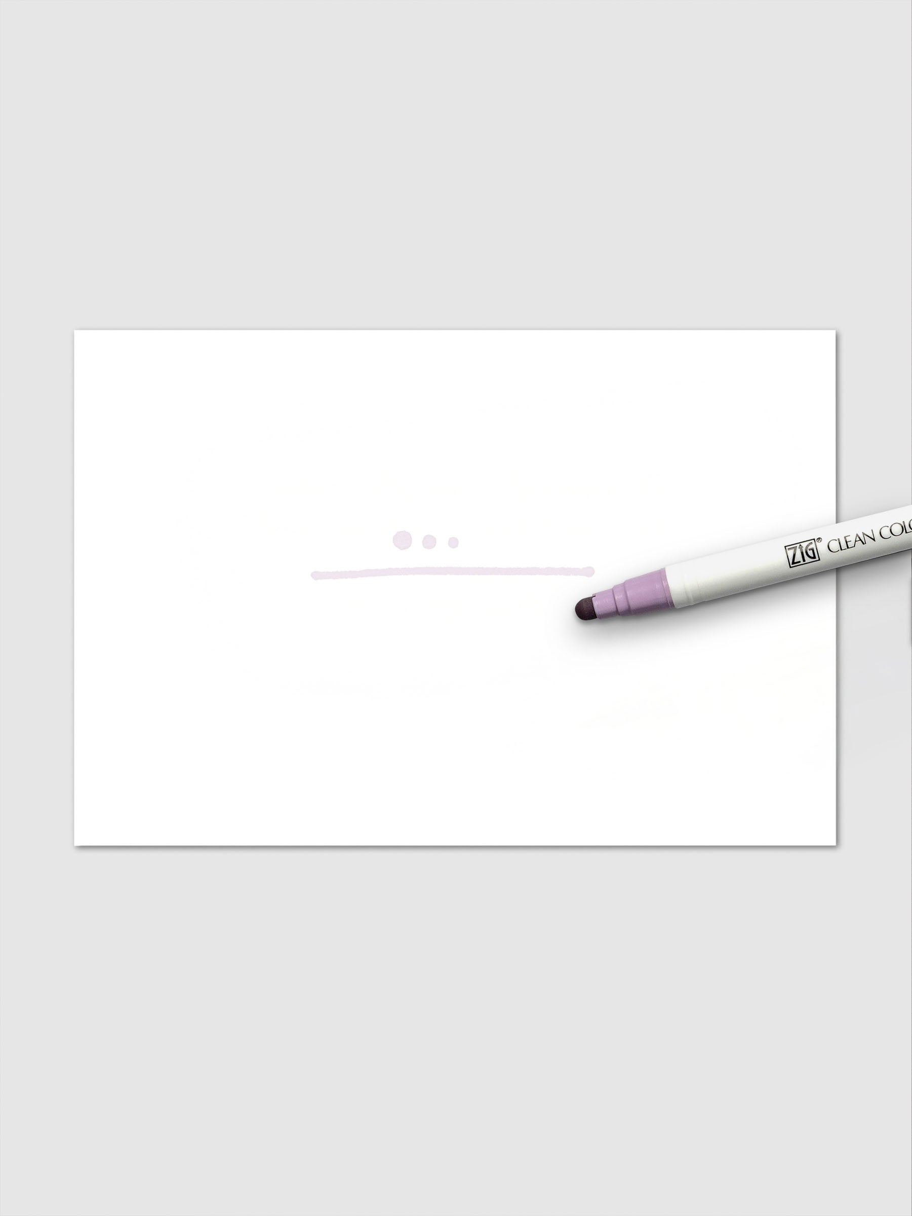 The Wisteria marker produces a pale purple line and three dots on white paper, placed next to the uncapped marker.