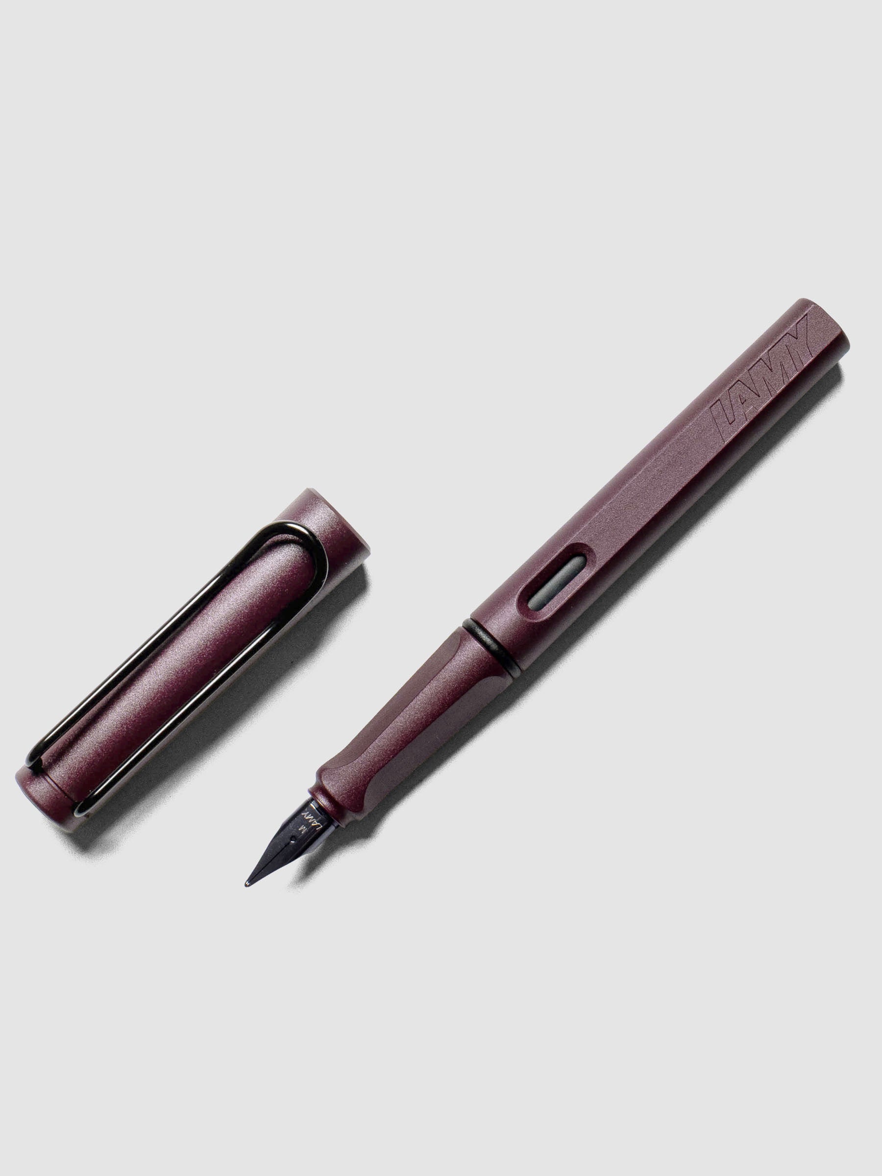 LAMY Safari Fountain Pen in the color Scarlett with Medium nib shown diagonally with the cap off. 