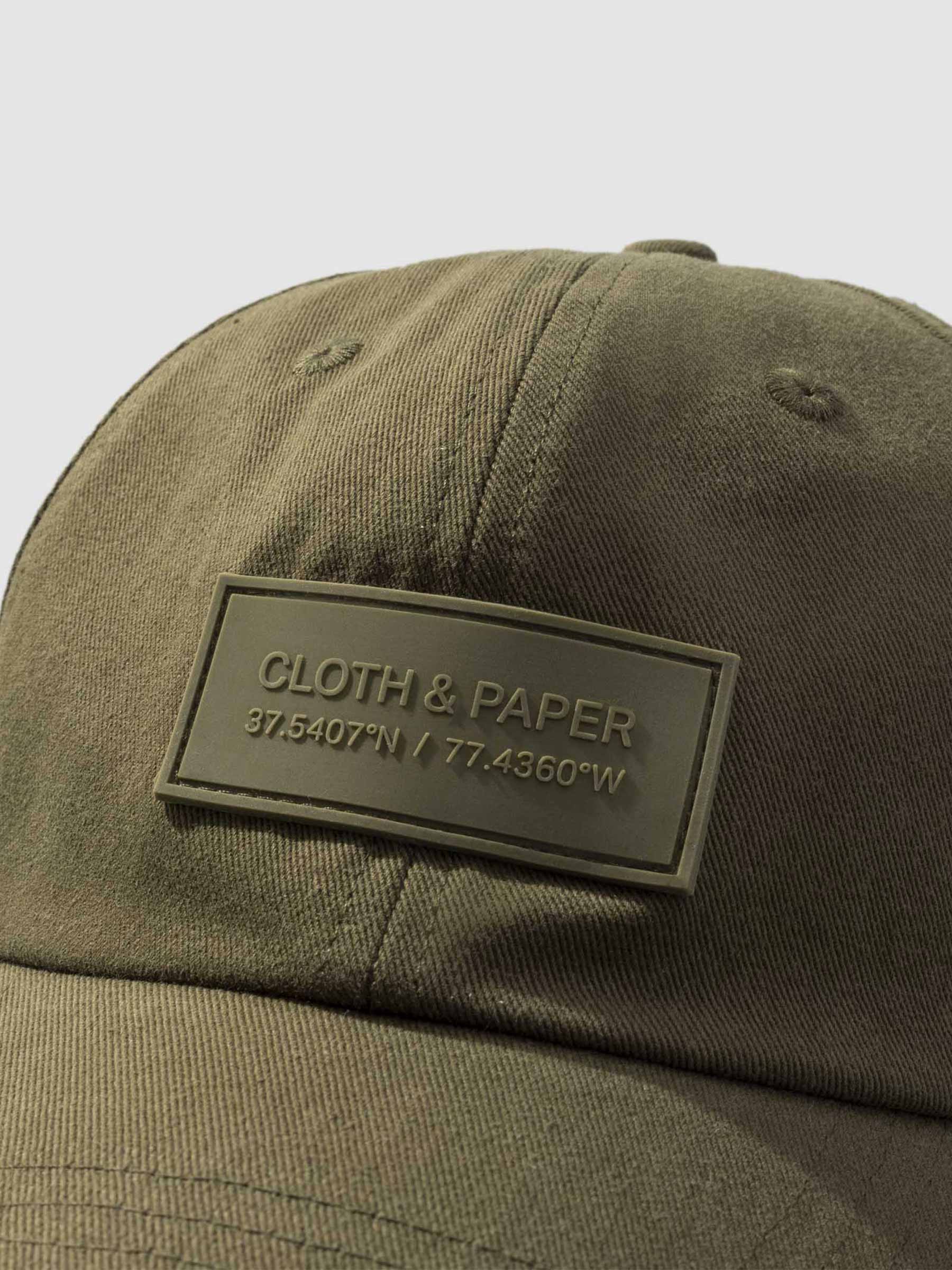 Label Hat, Cloth and Paper. Hat displayed on a neutral background. Closeup of silicone tag label.