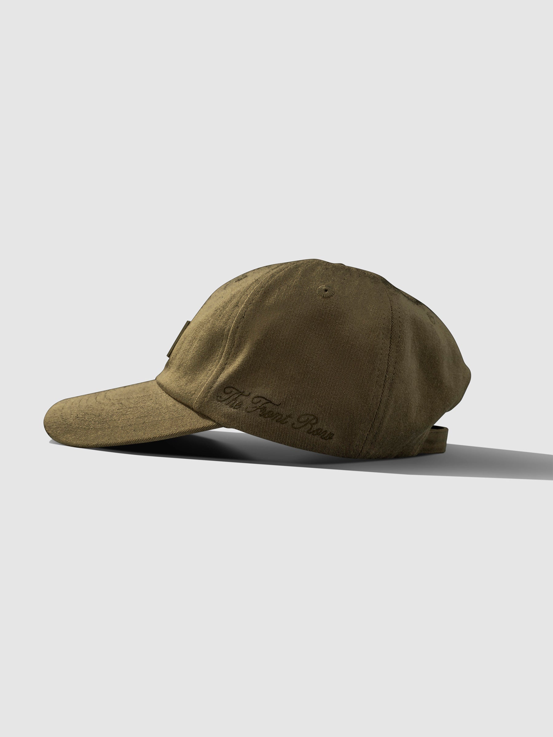 Label Hat, Cloth and Paper. Hat displayed on a neutral background. Hat is viewed from the side and showcases embroidered detailing.