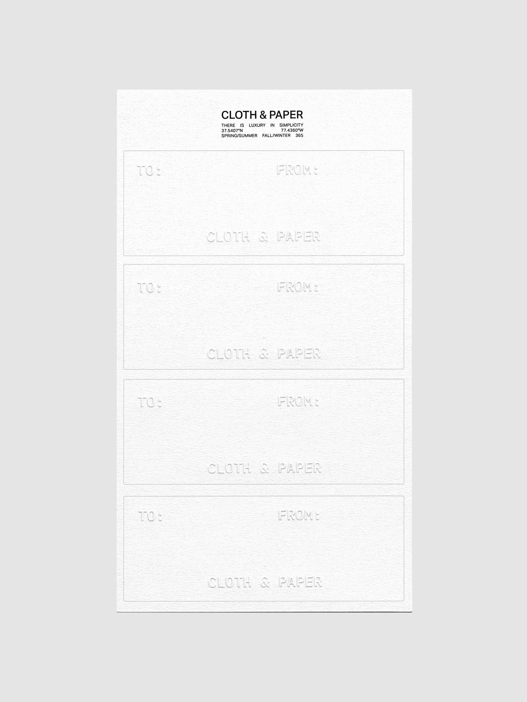 One sheet of white Label Planner Stickers | Gift Tag including four stickers shown on a neutral background.