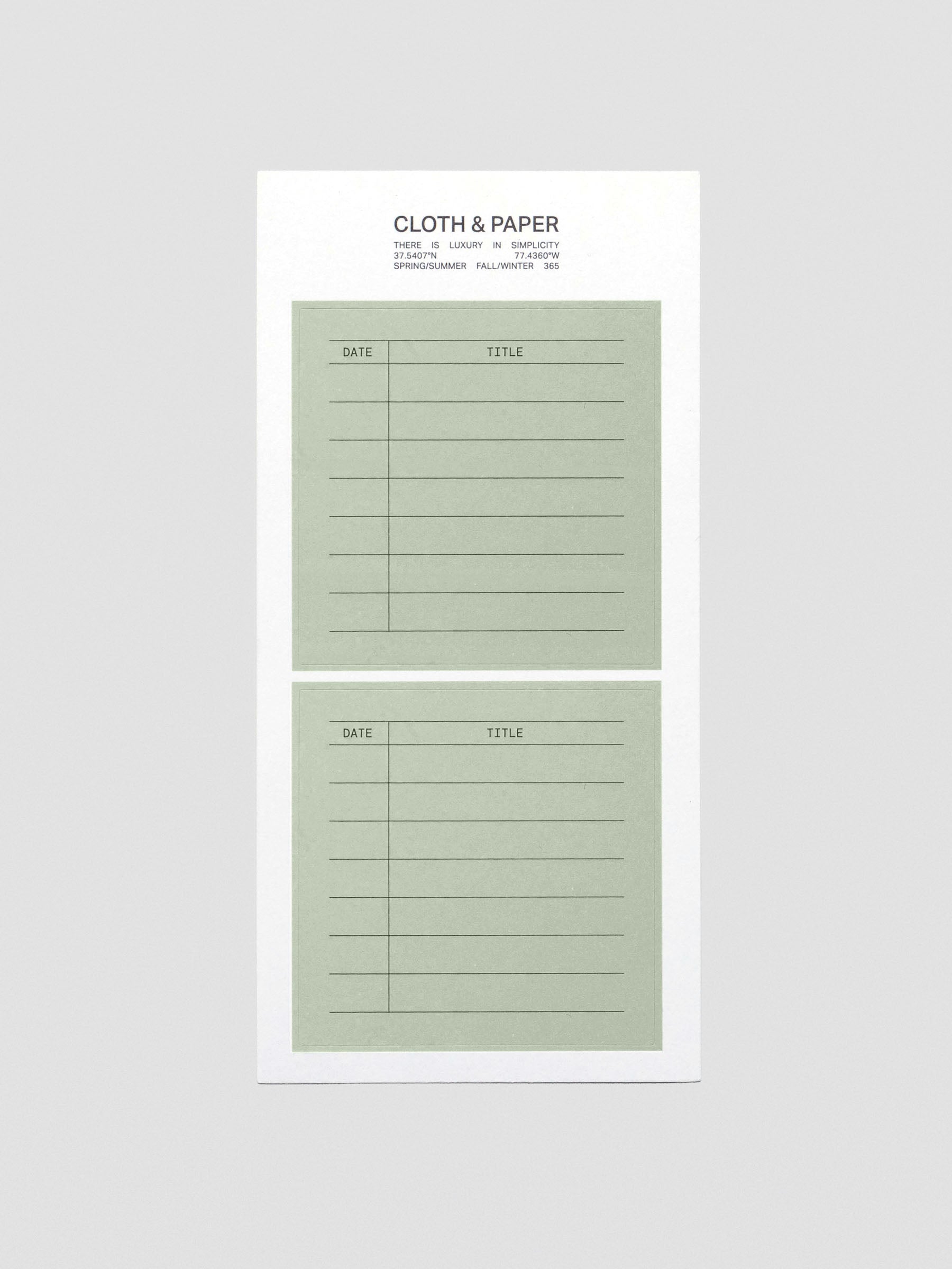 A sheet of two green, square labels with headers for date and title.