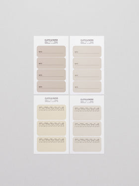 Four sheets of Cloth & Paper Label Planner Stickers titled "Note," displayed on a light grey background. The top two sheets feature rectangular beige stickers labeled "Note" with a line for writing, while the bottom two sheets feature beige stickers with a minimalist yearly calendar printed on each label