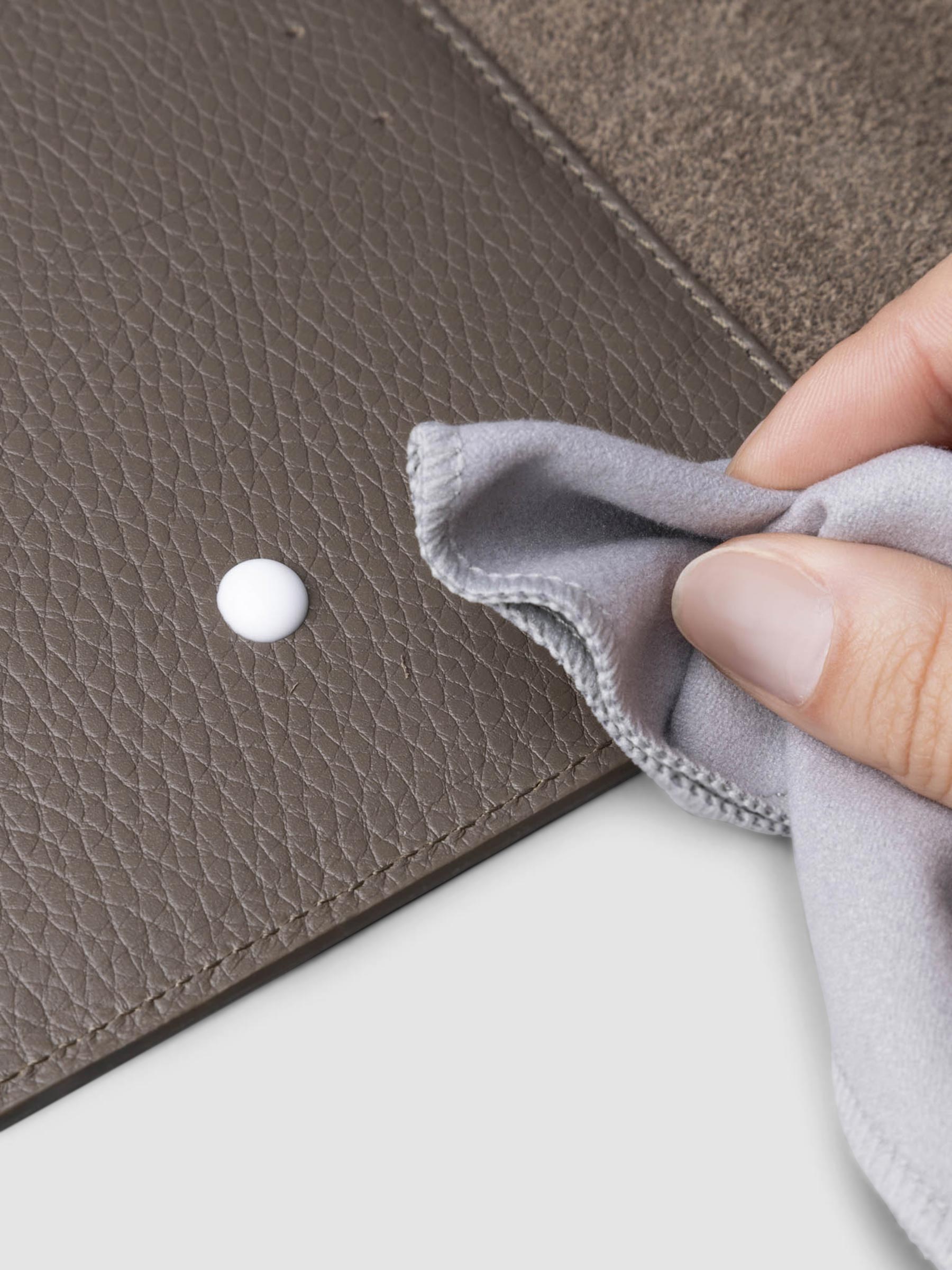 Conditioner in use inside a brown leather agenda.