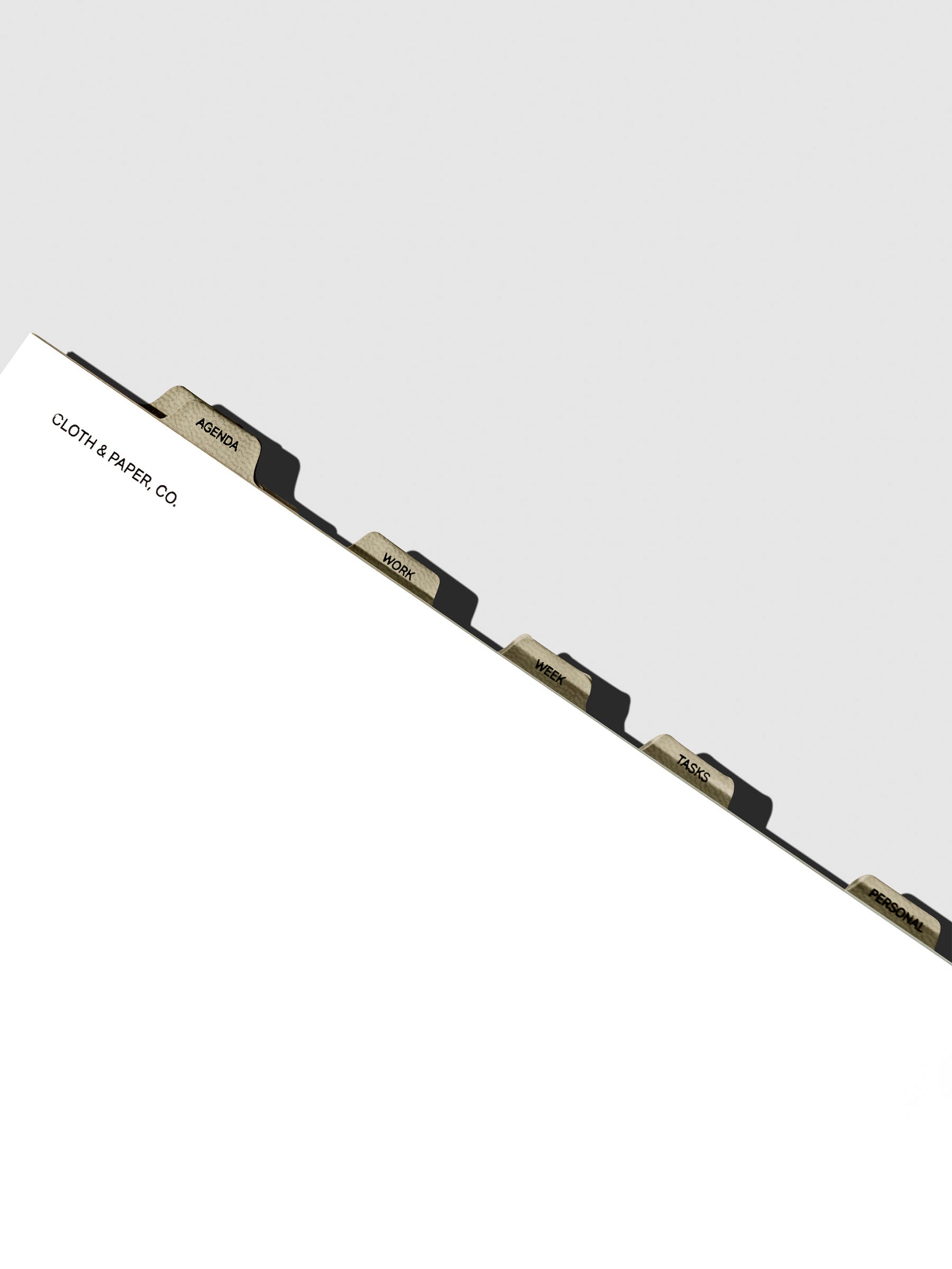 Dividers in use inside a white notebook.