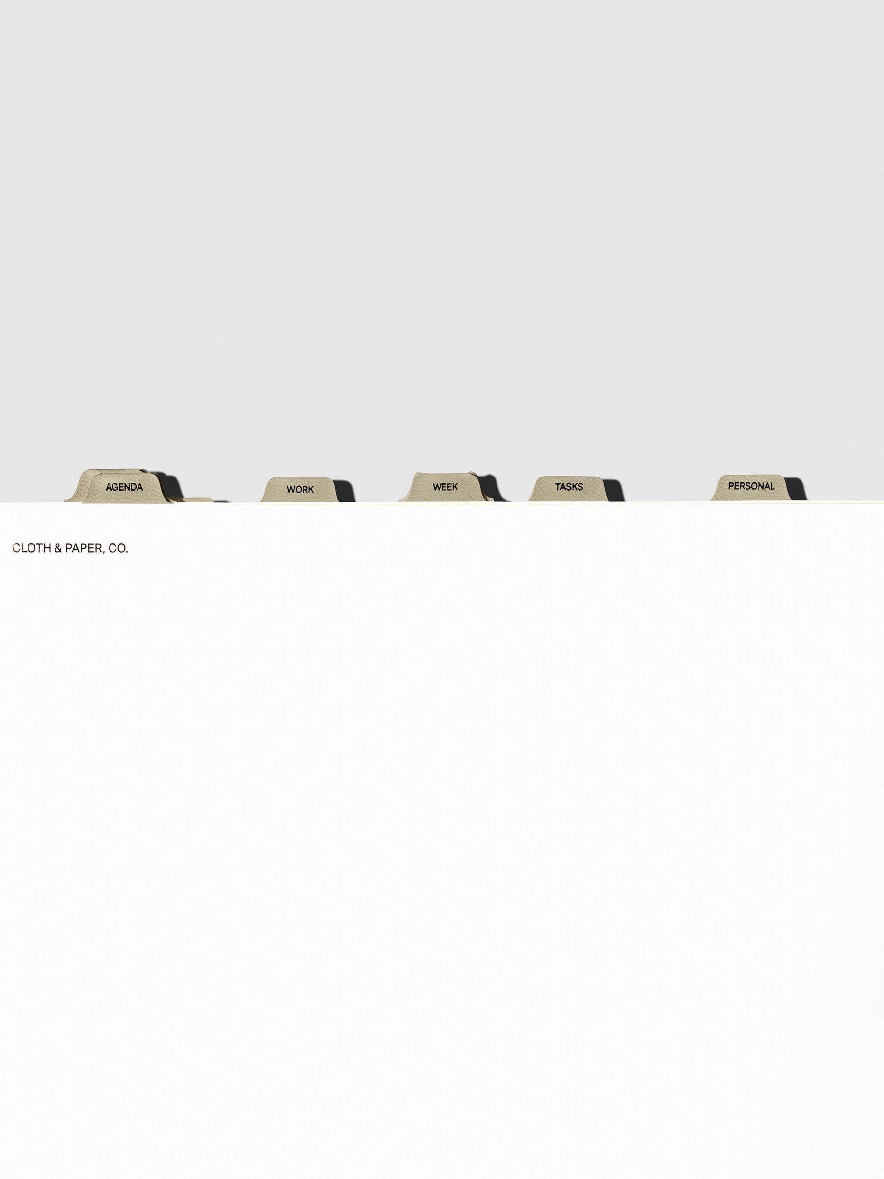 Dividers in use inside a white notebook.