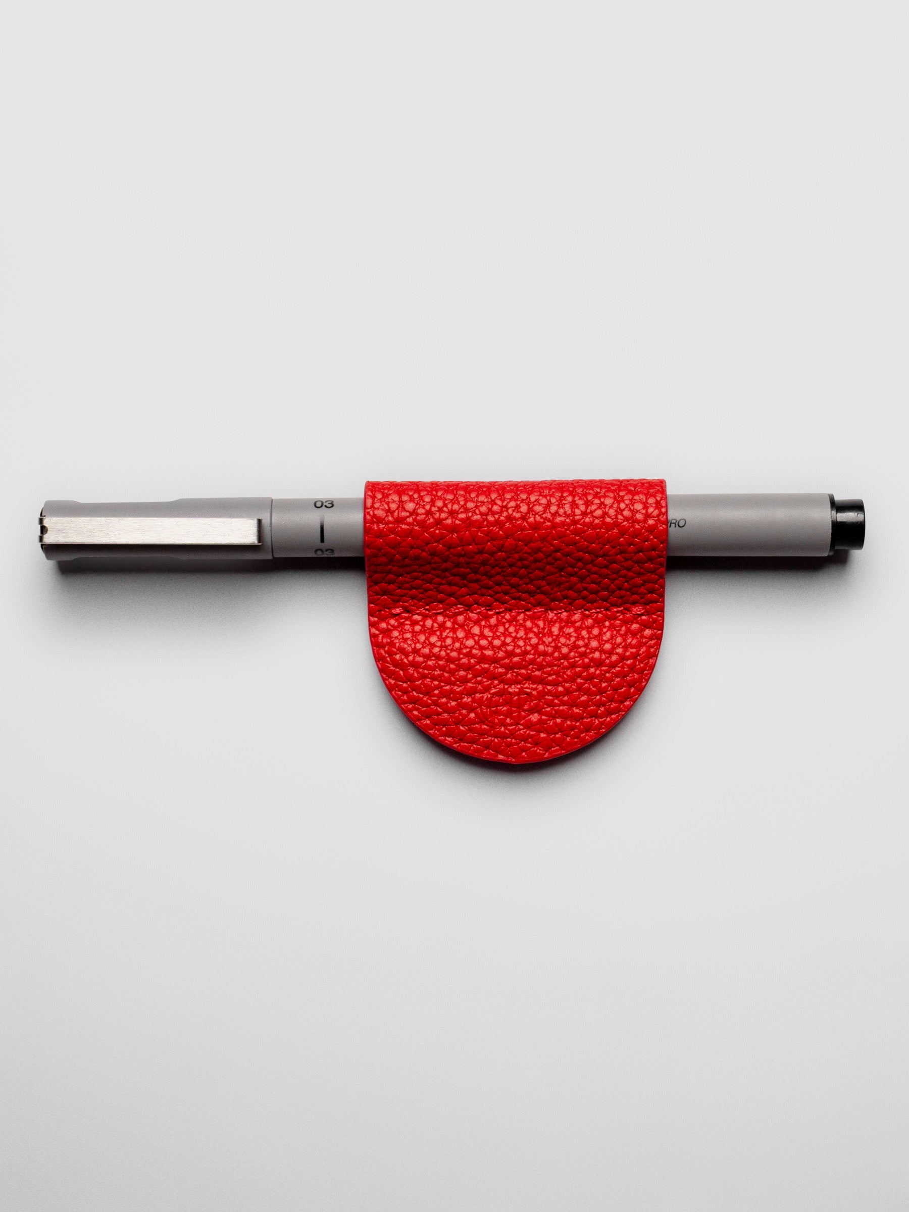 Rouge clip displayed on a neutral background. A Uni Pin Marking Pen is placed inside the pen clip.