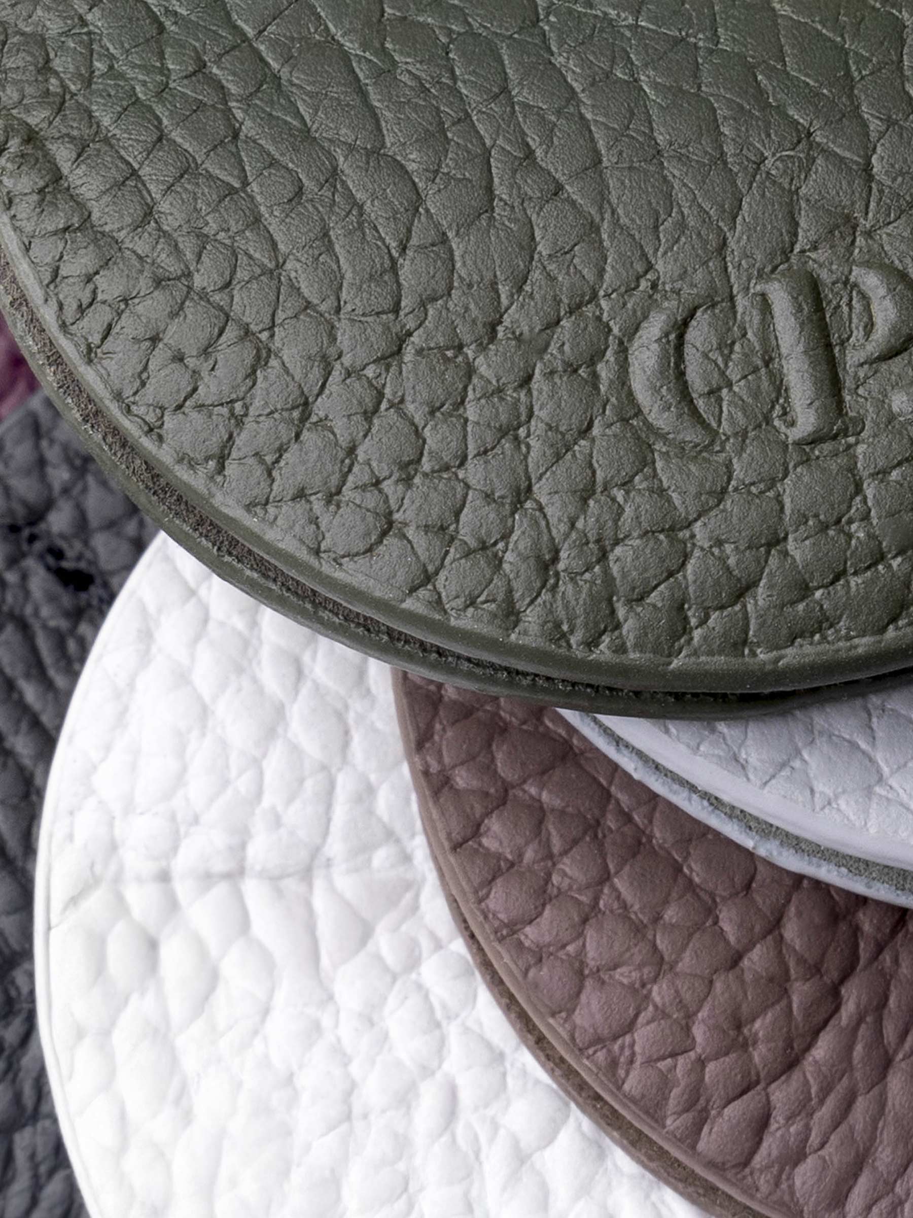 Closeup of six clips showcasing the texture of their leather construction.