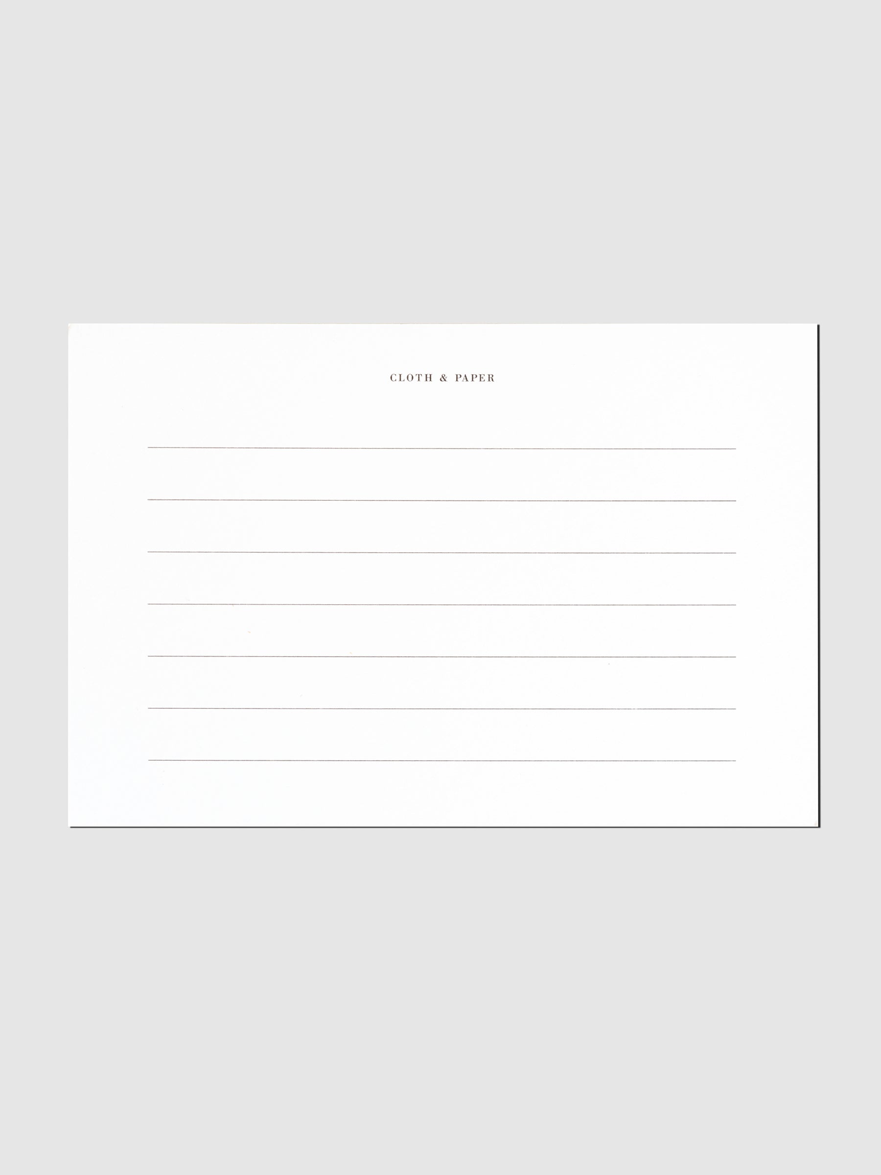 Back side of postcard which is printed with lined notes.