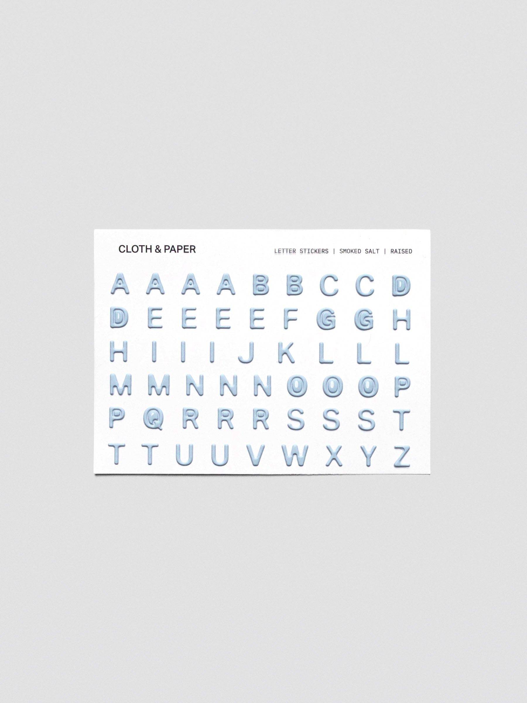 One sheet of blue grey raised letter stickers.