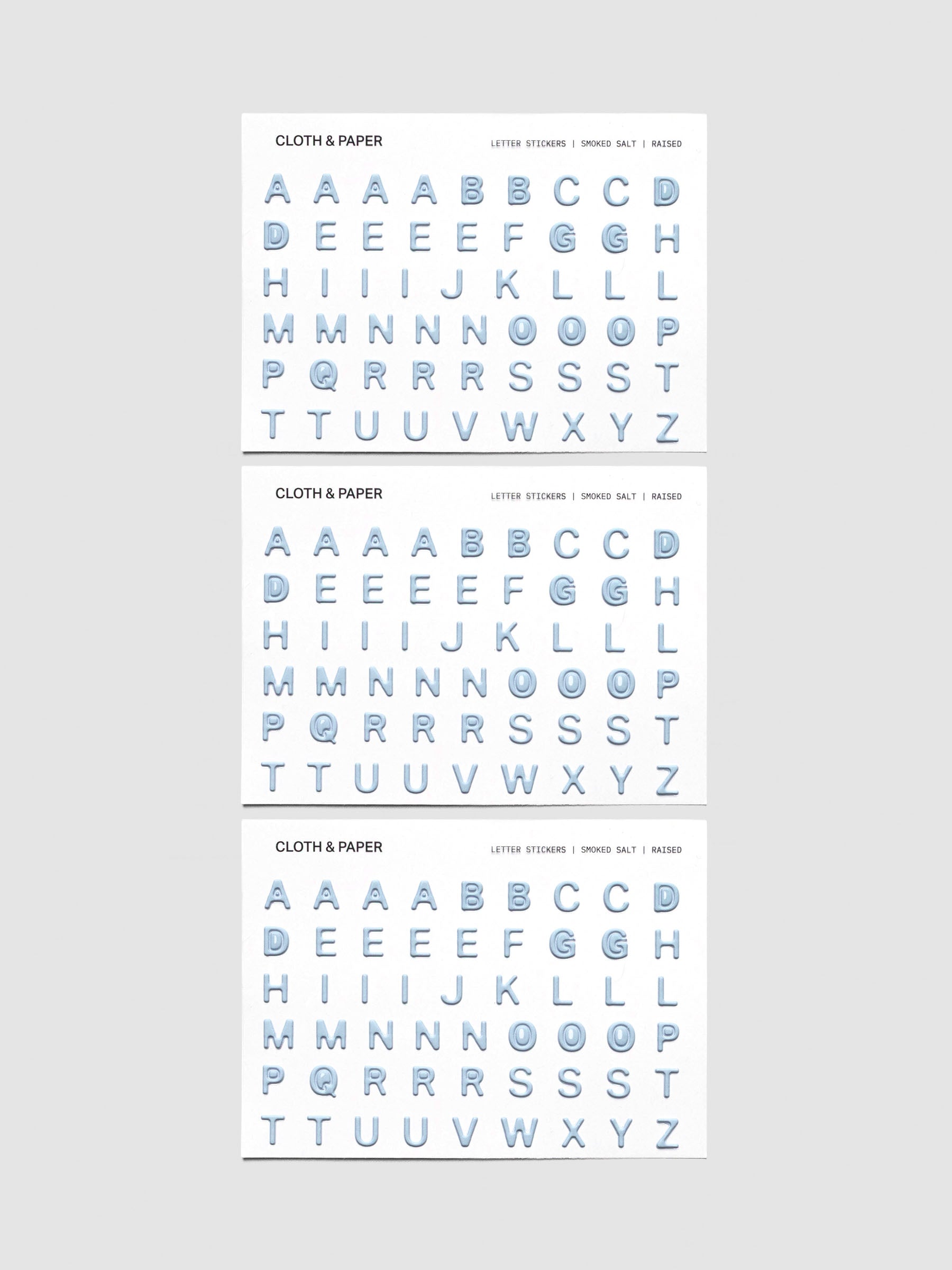 Three sheets of blue grey raised letter stickers.