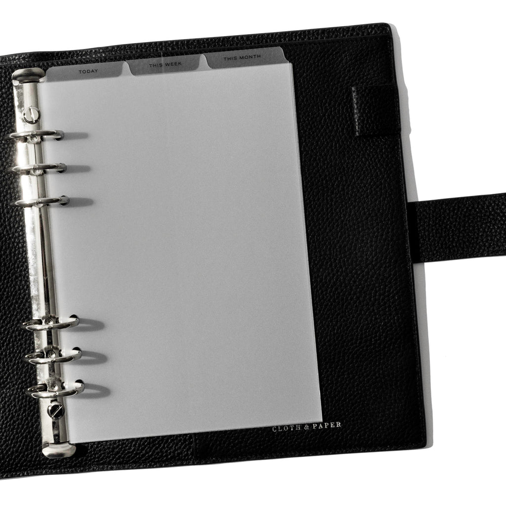 A5 6-Ring Black Foil Cadence Tab Dividers displayed in a black leather planner.