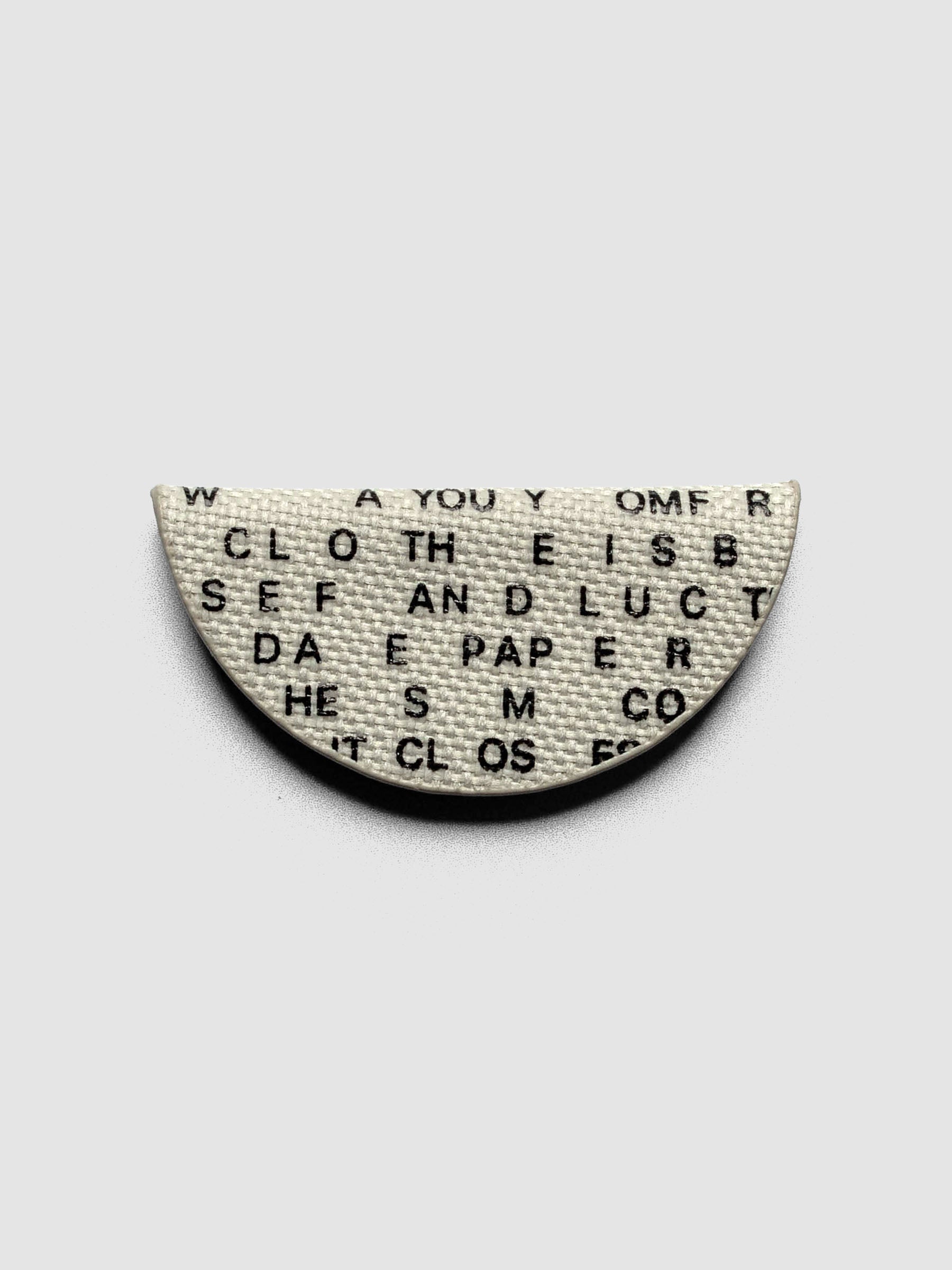 Magnetic Bookmark | Bookcloth | Letters folded in half on a neutral background.