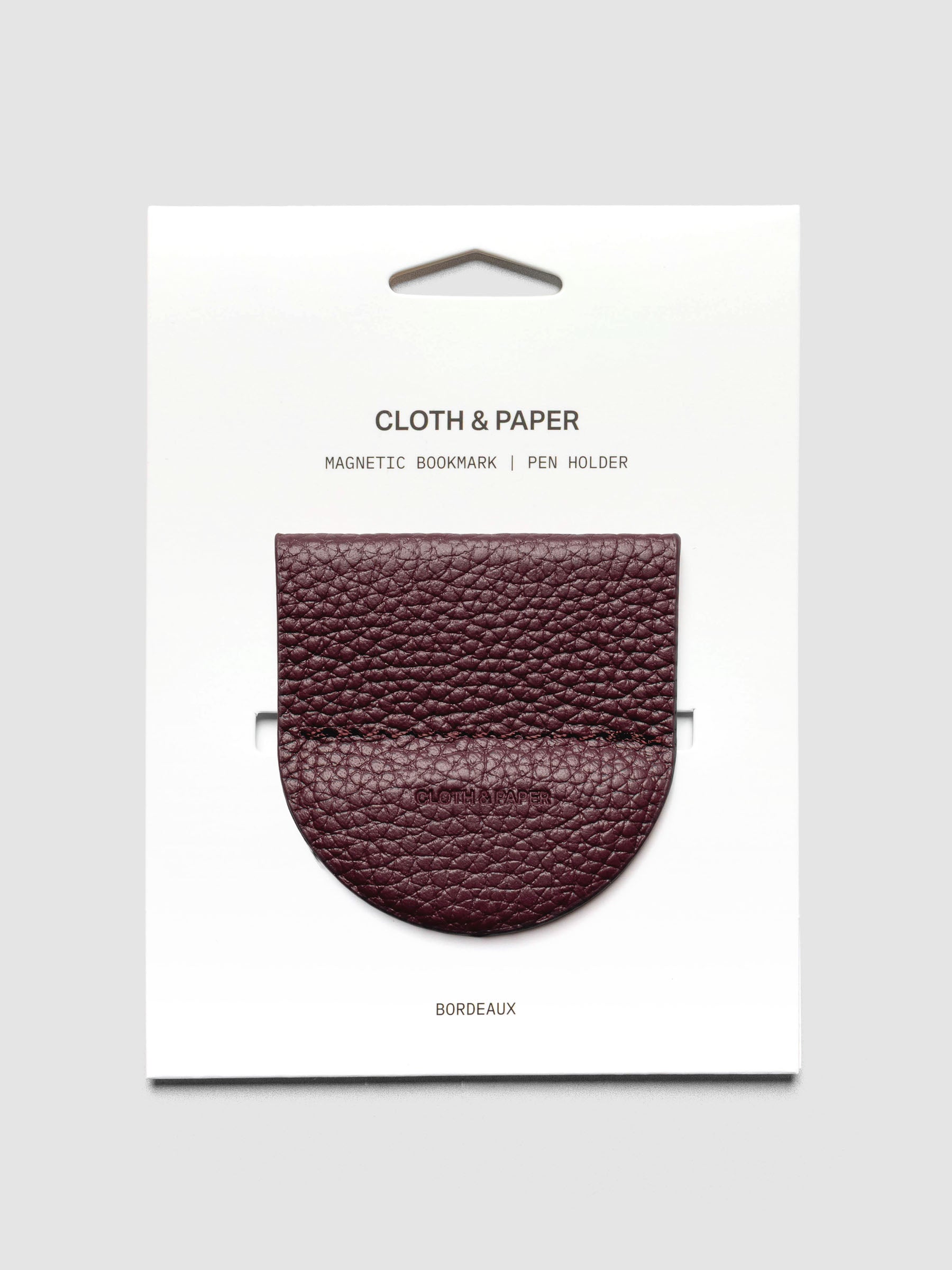 Magnetic Bookmark | Pen Holder in Bordeaux, a deep red, displayed on a white backing card against a neutral background.