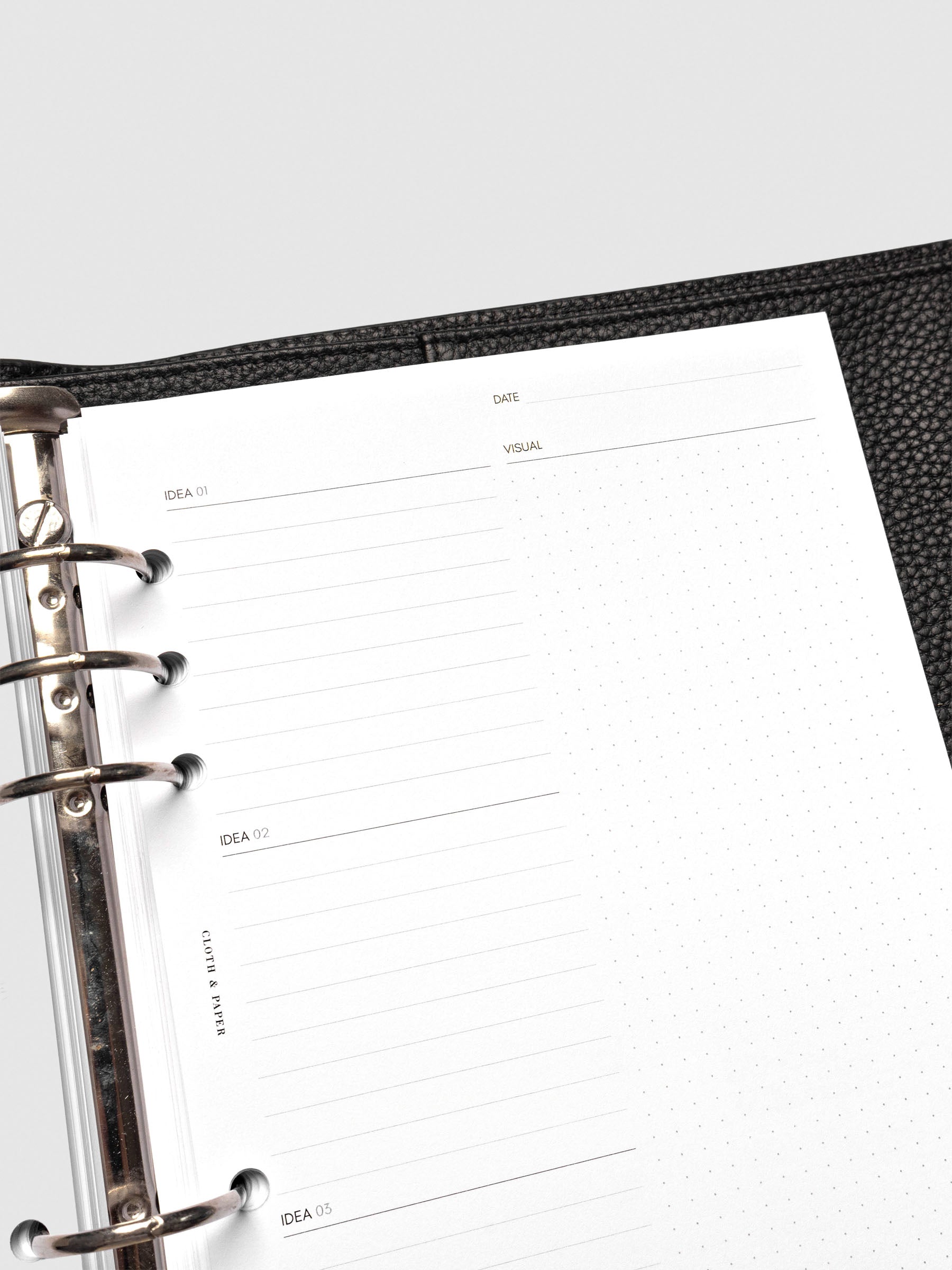 Close up of Mental Download inserts inside discbound planner and leather cover.