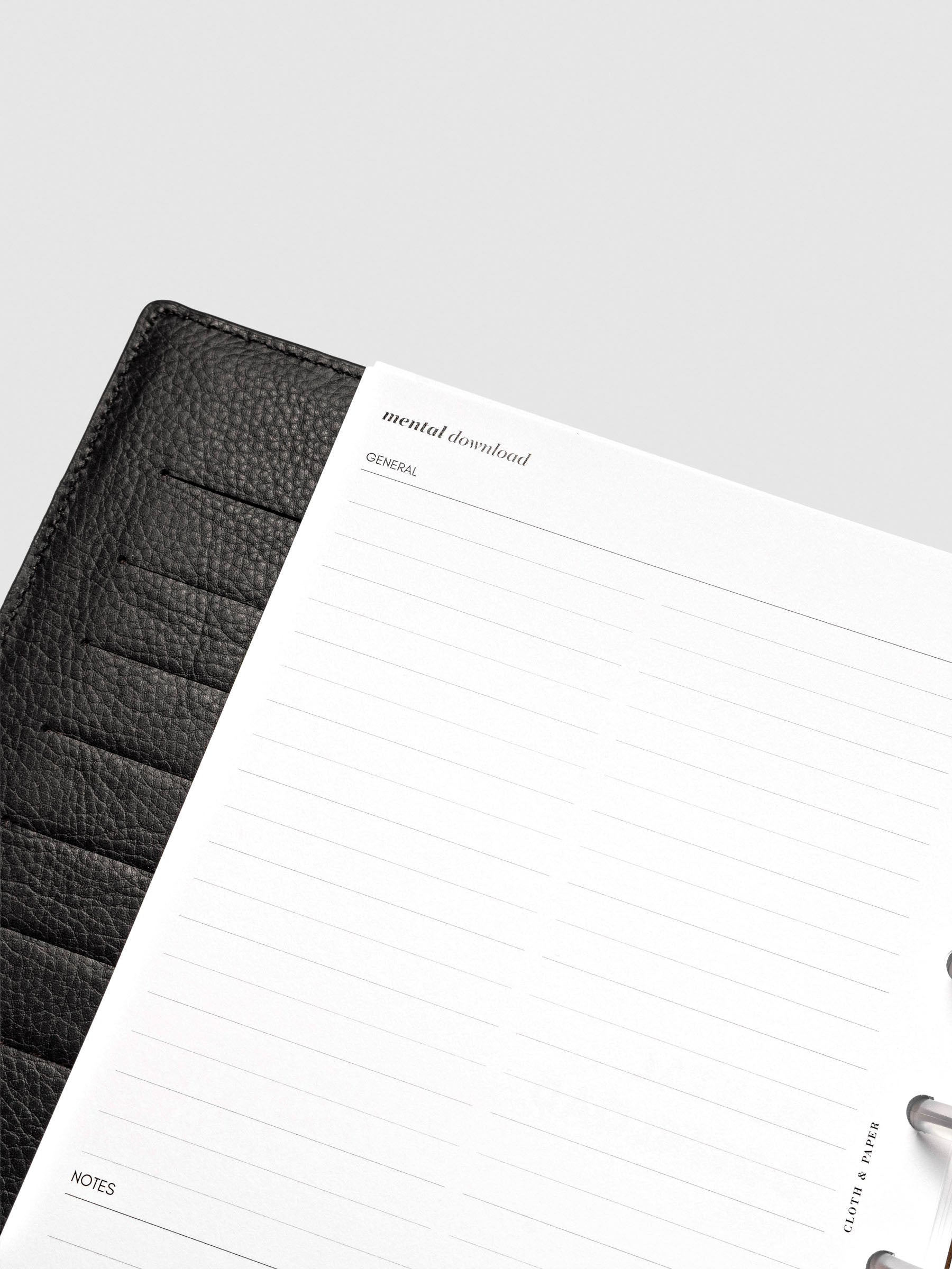 Close up of Mental Download inserts inside discbound planner and leather cover.