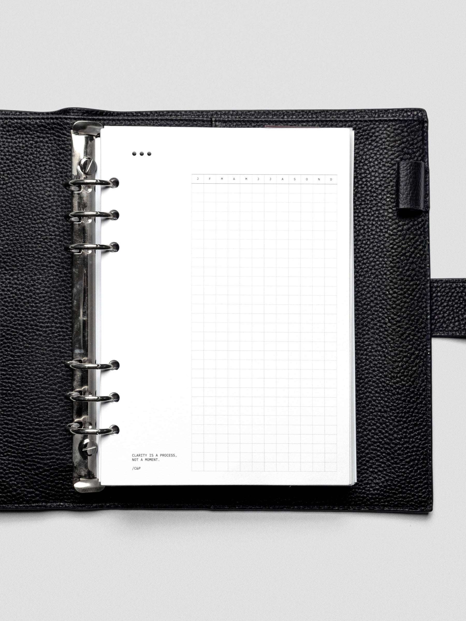 Mindful Moments Planner Dashboard in A5 size shown in a ring bound leather planner cover.