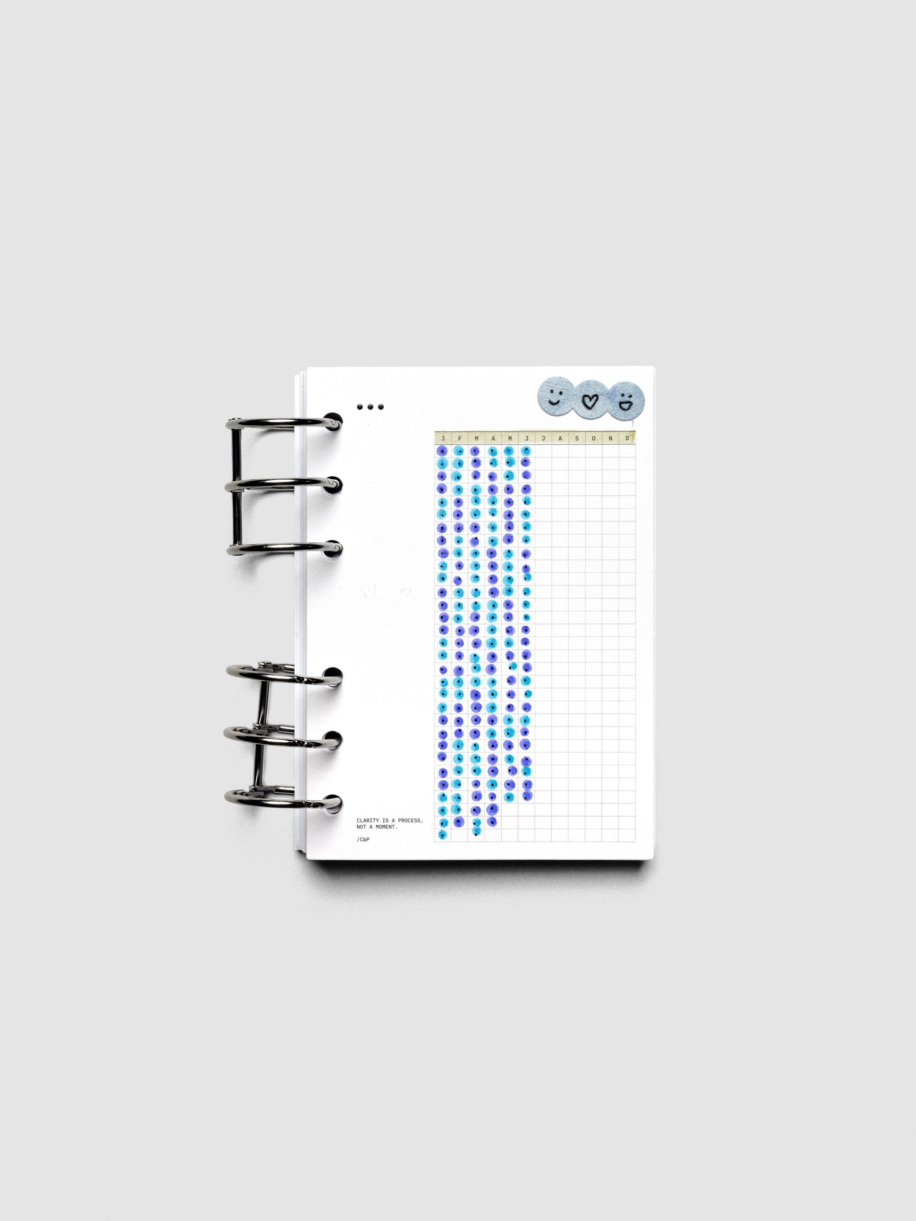 Mindful Moments Planner Dashboard in A6 size shown ring bound and filled out with various highlighters and markers.