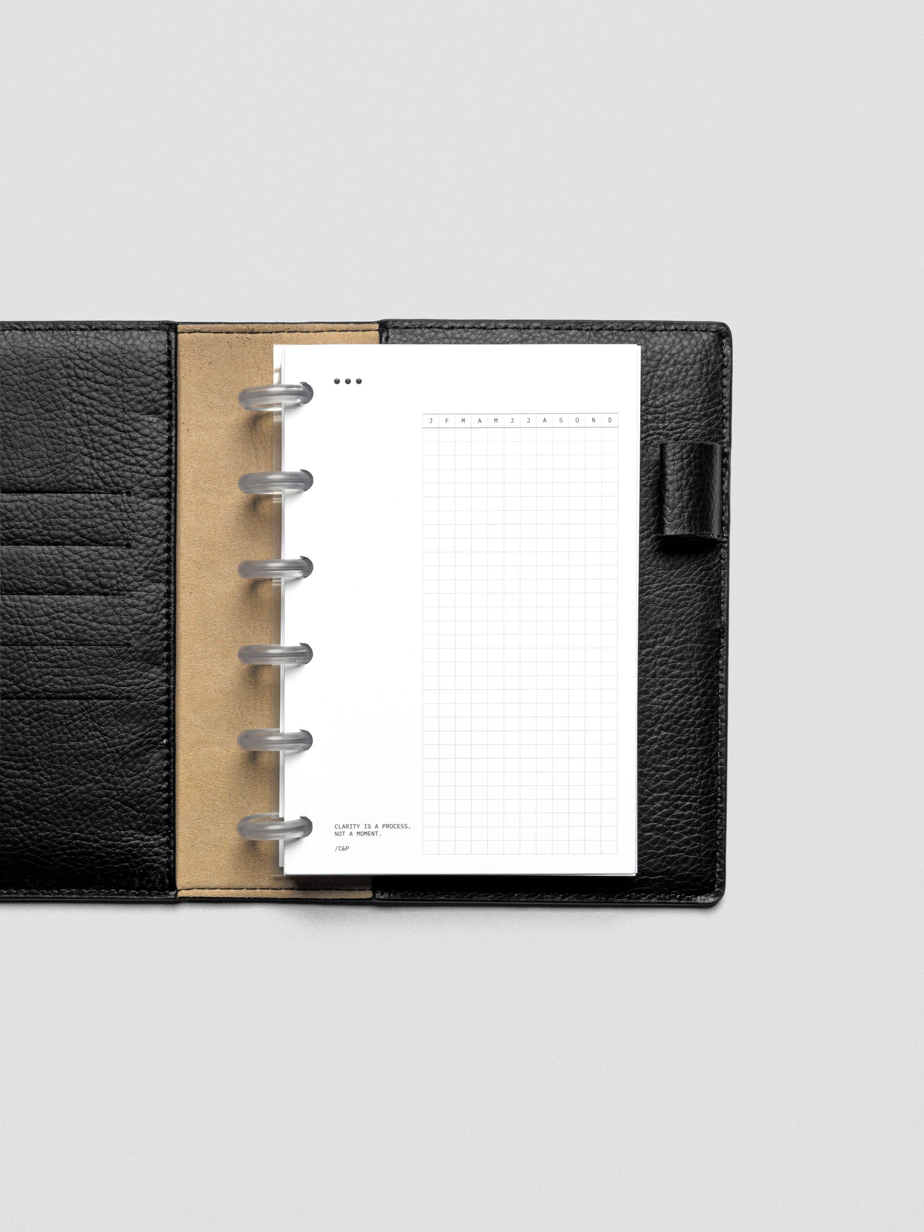 Mindful Moments Planner Dashboard in CP Petite size shown disc bound in a leather planner cover.
