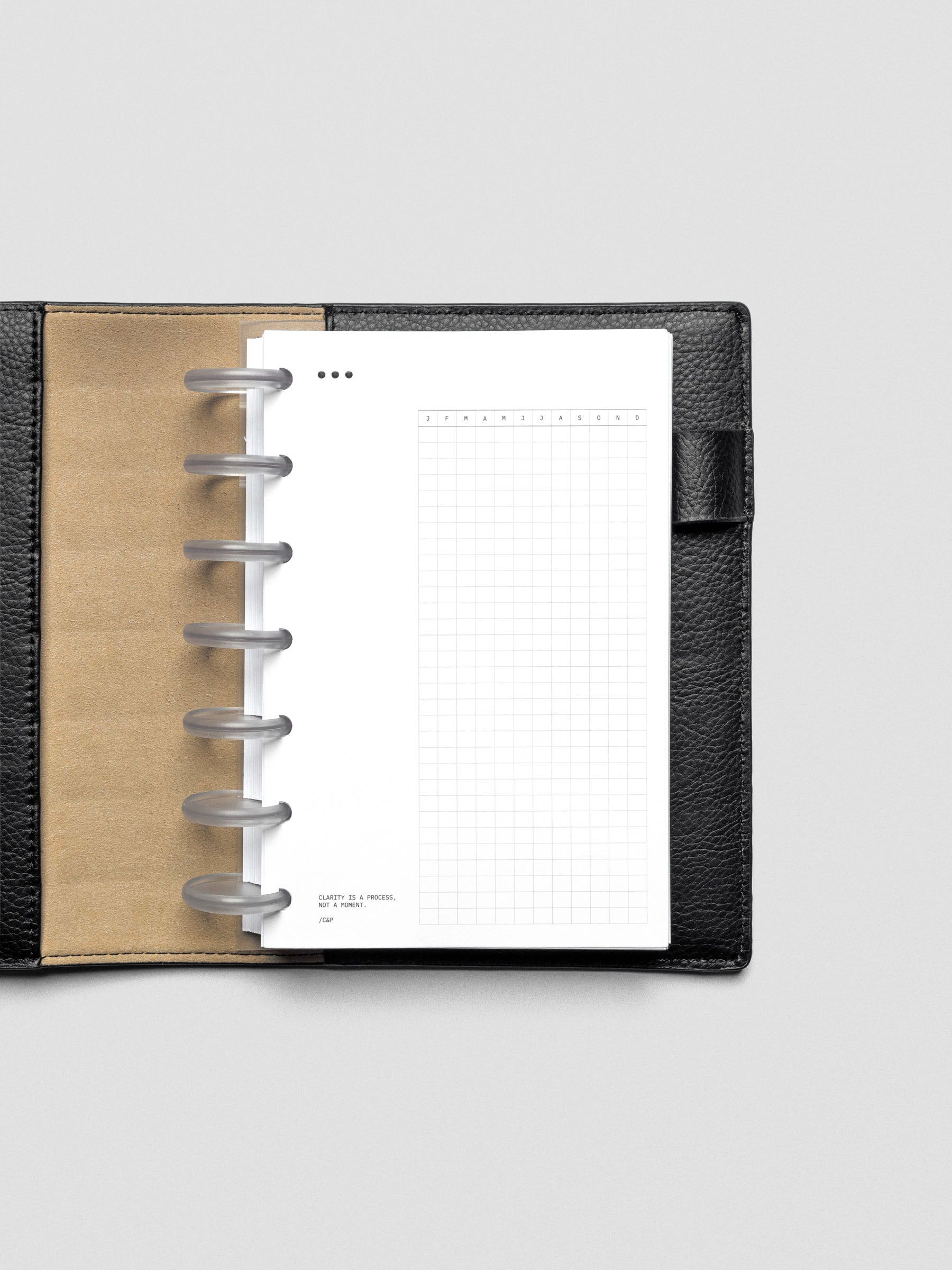 Mindful Moments Planner Dashboard in HP Mini size shown disc bound in a leather planner cover.