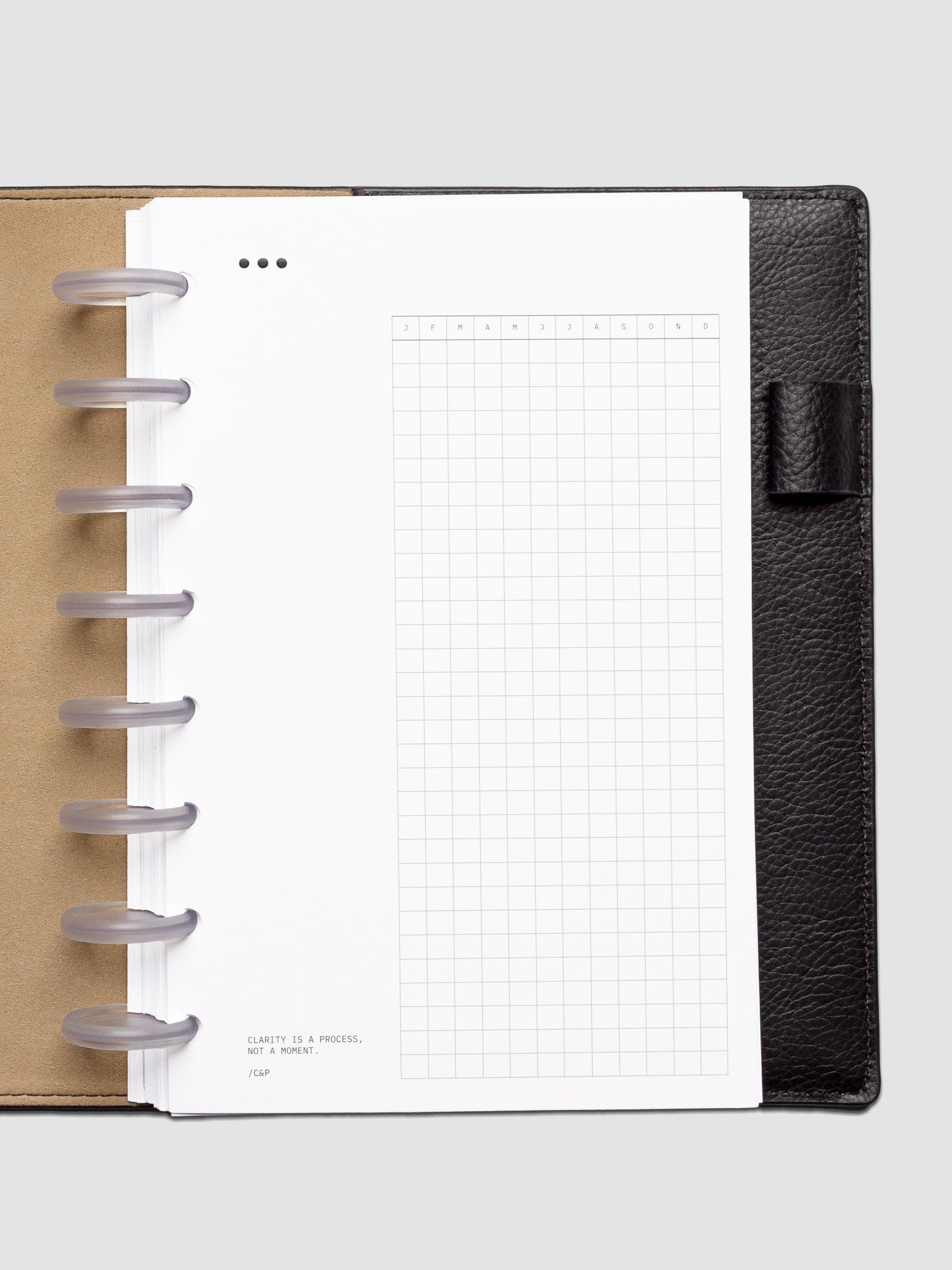 Mindful Moments Planner Dashboard in Half Letter size shown discbound in a leather folio.