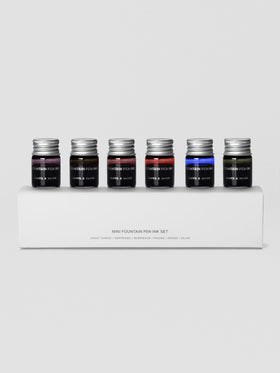 Set of six miniature bottles of fountain pen ink in six unique colors shown in packaging.