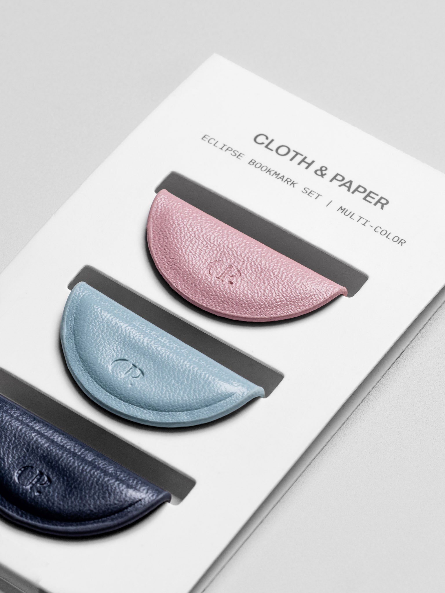 Close up angled view of Mini Magnetic Bookmarks | Vol. 3 on a backing card; each with a CP imprint.