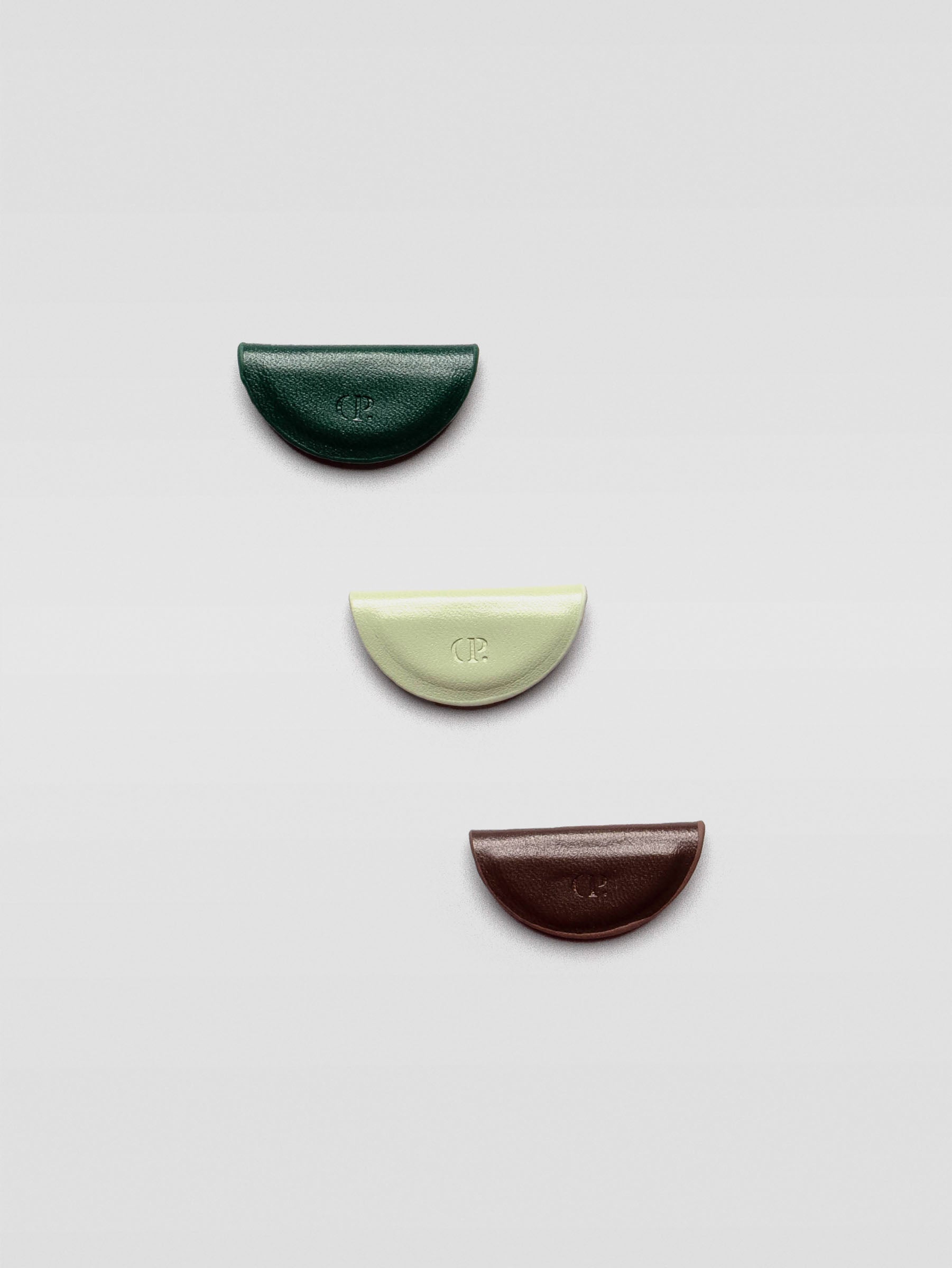 The same three bookmarks displayed flat and separated on a light gray background, showing their individual shapes and colors.